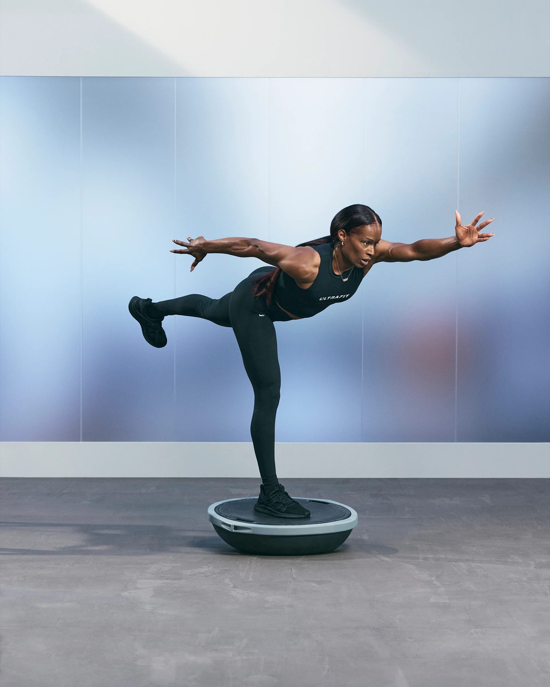 a woman in a bosu heisman pose