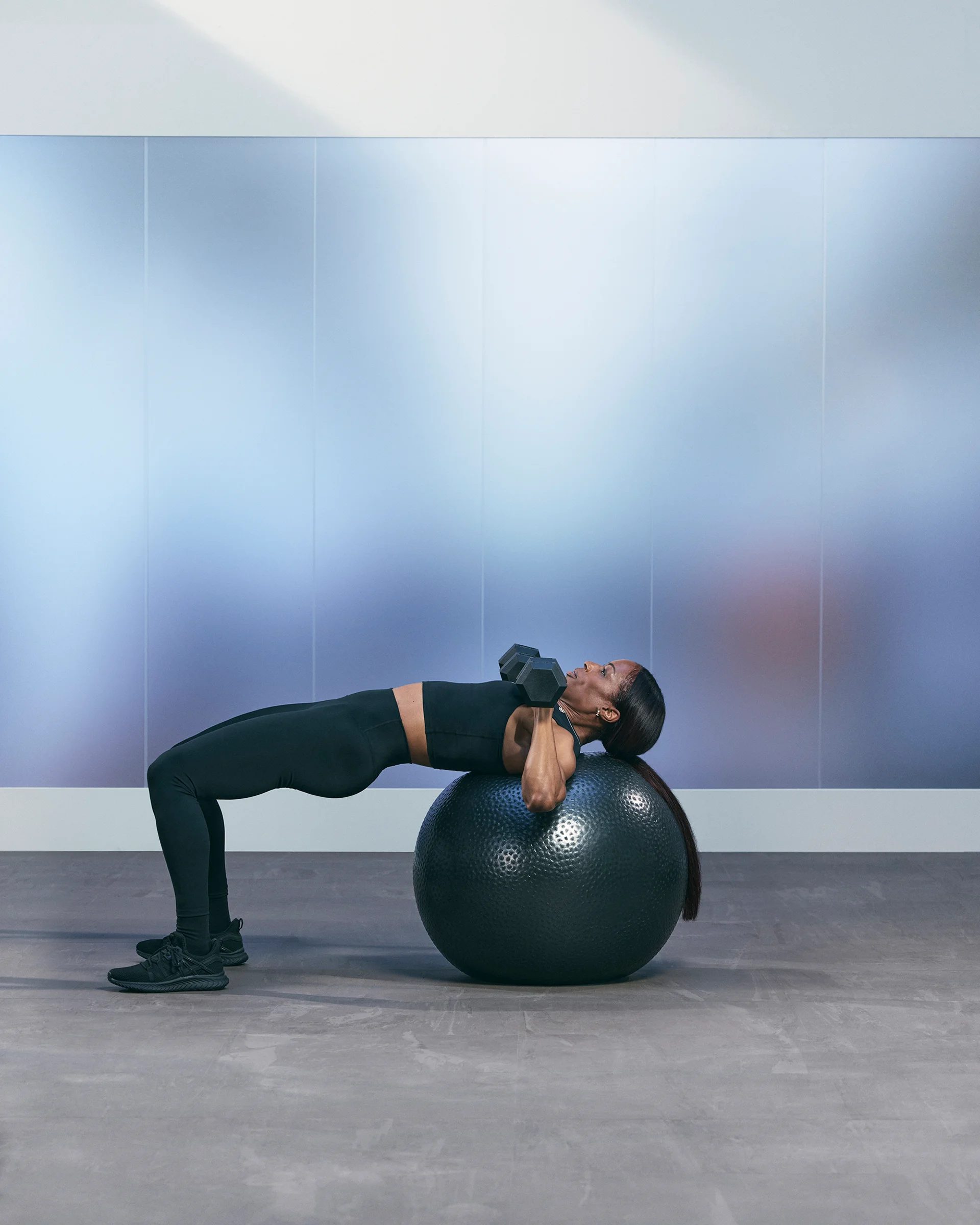a woman doing a single leg chest press on a stability ball