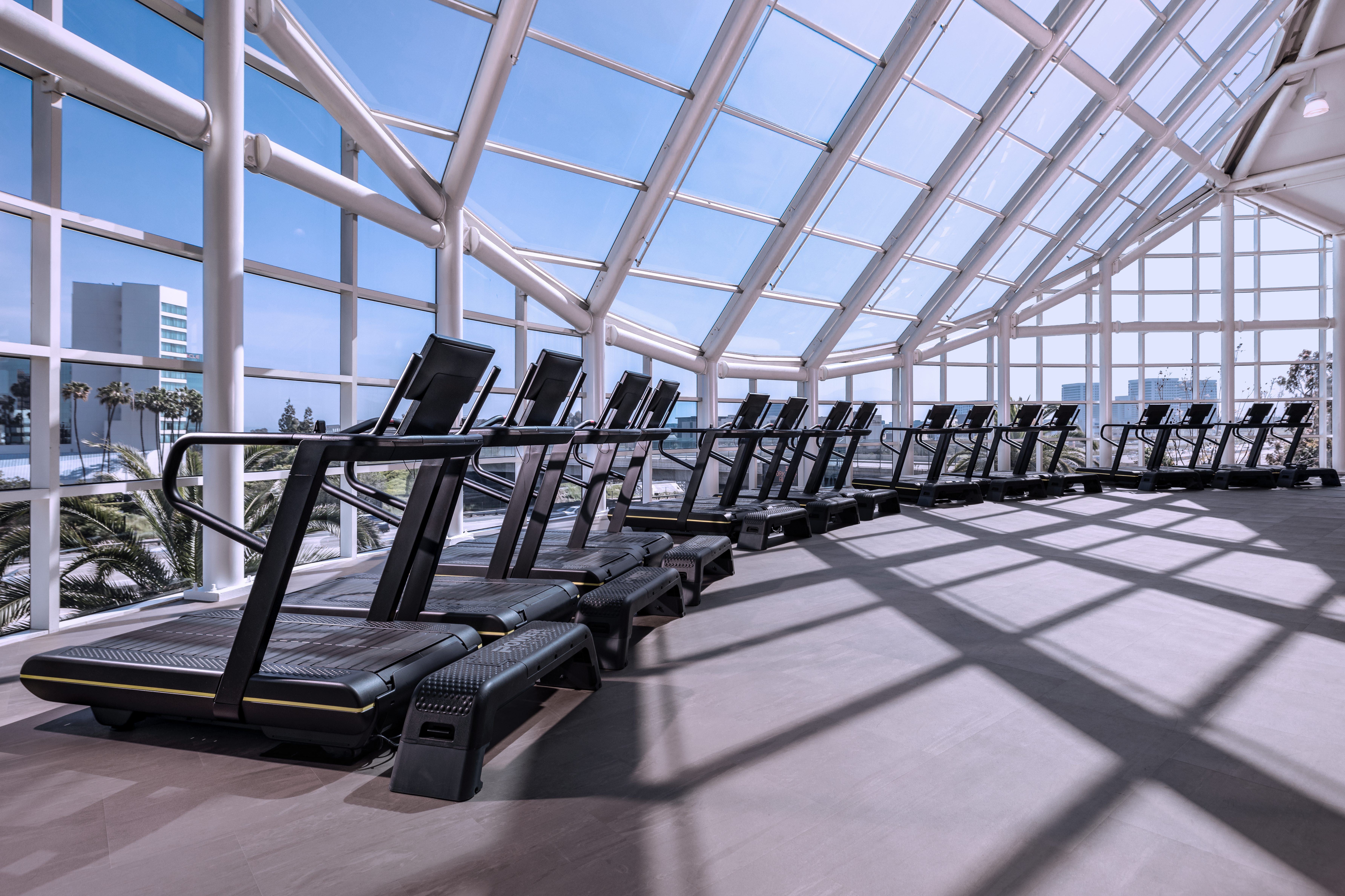 Treadmills lined up on the fitness floor at the Life Time Lakeshore Irvine club location