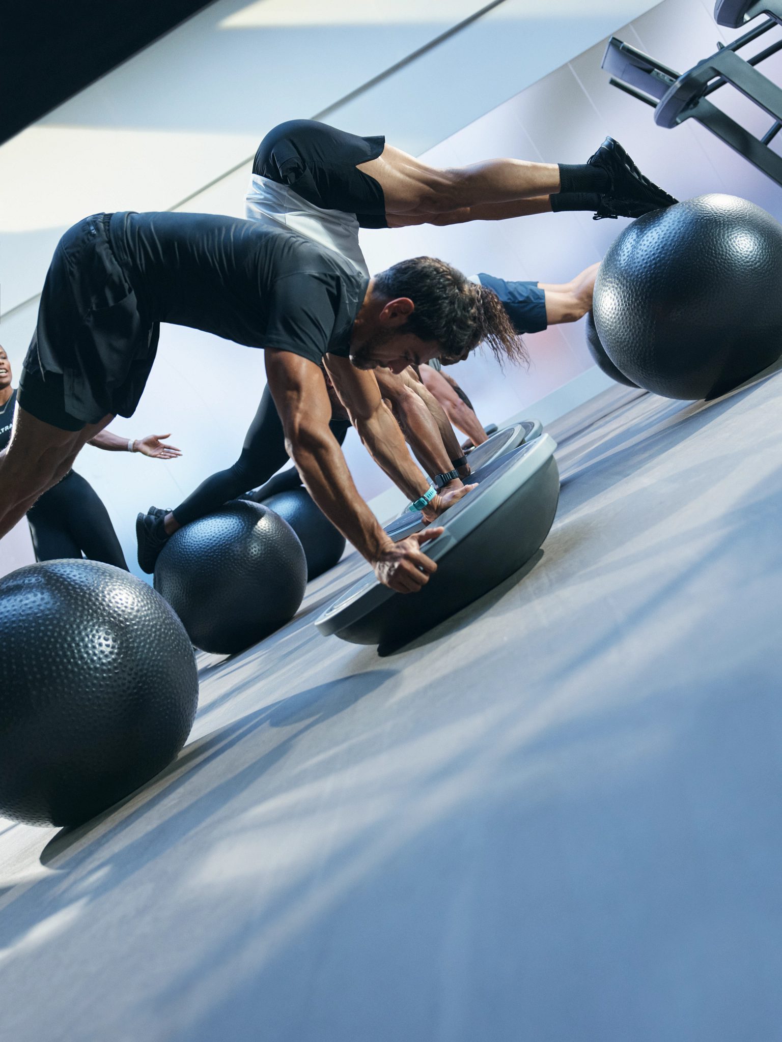 Class using bosu balls and yoga balls in an UltraFit boutique group training class