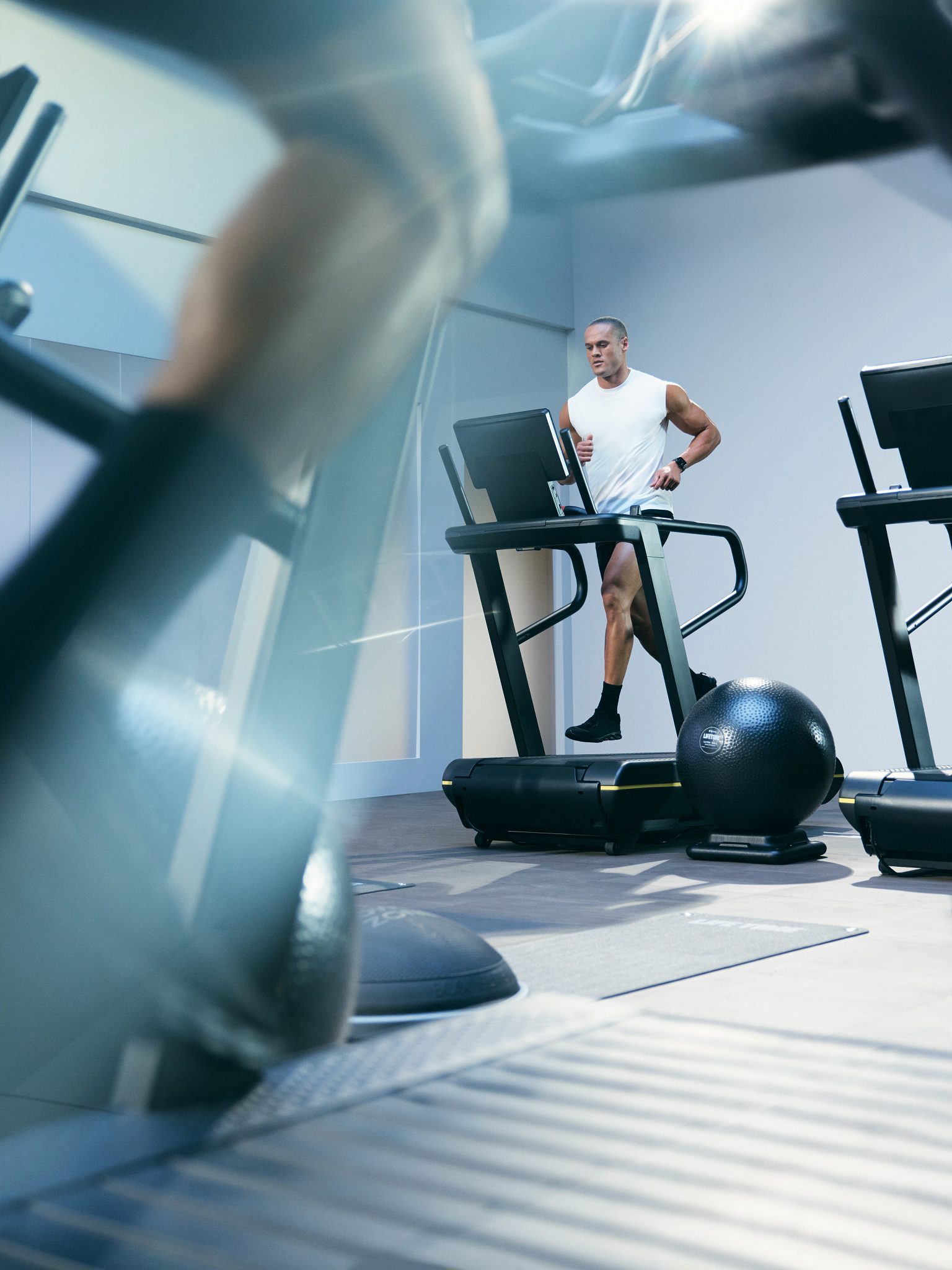 Person running on a treadmill in the UltraFit boutique group training class
