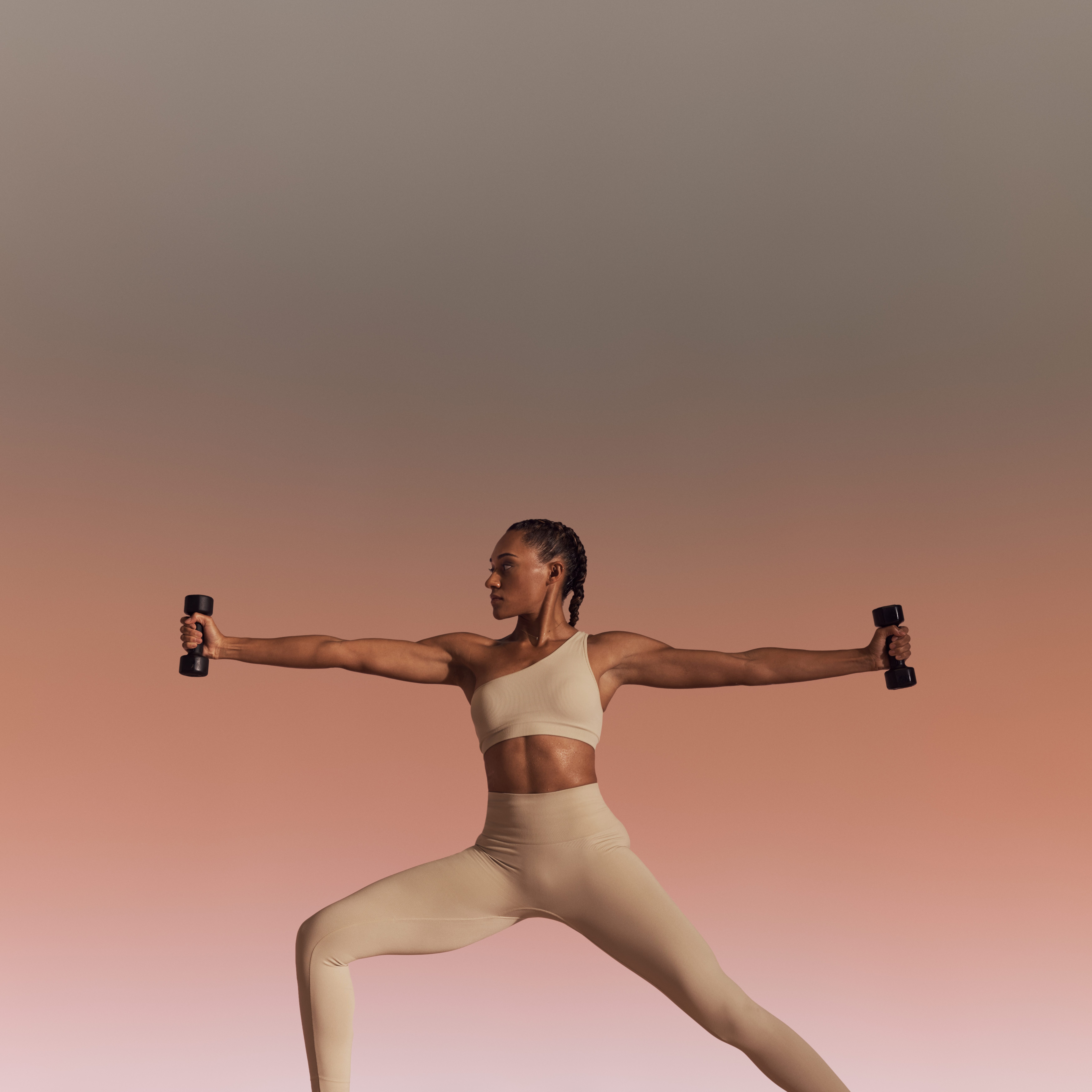 Life Time member using hand weights in warrior sculpt yoga class