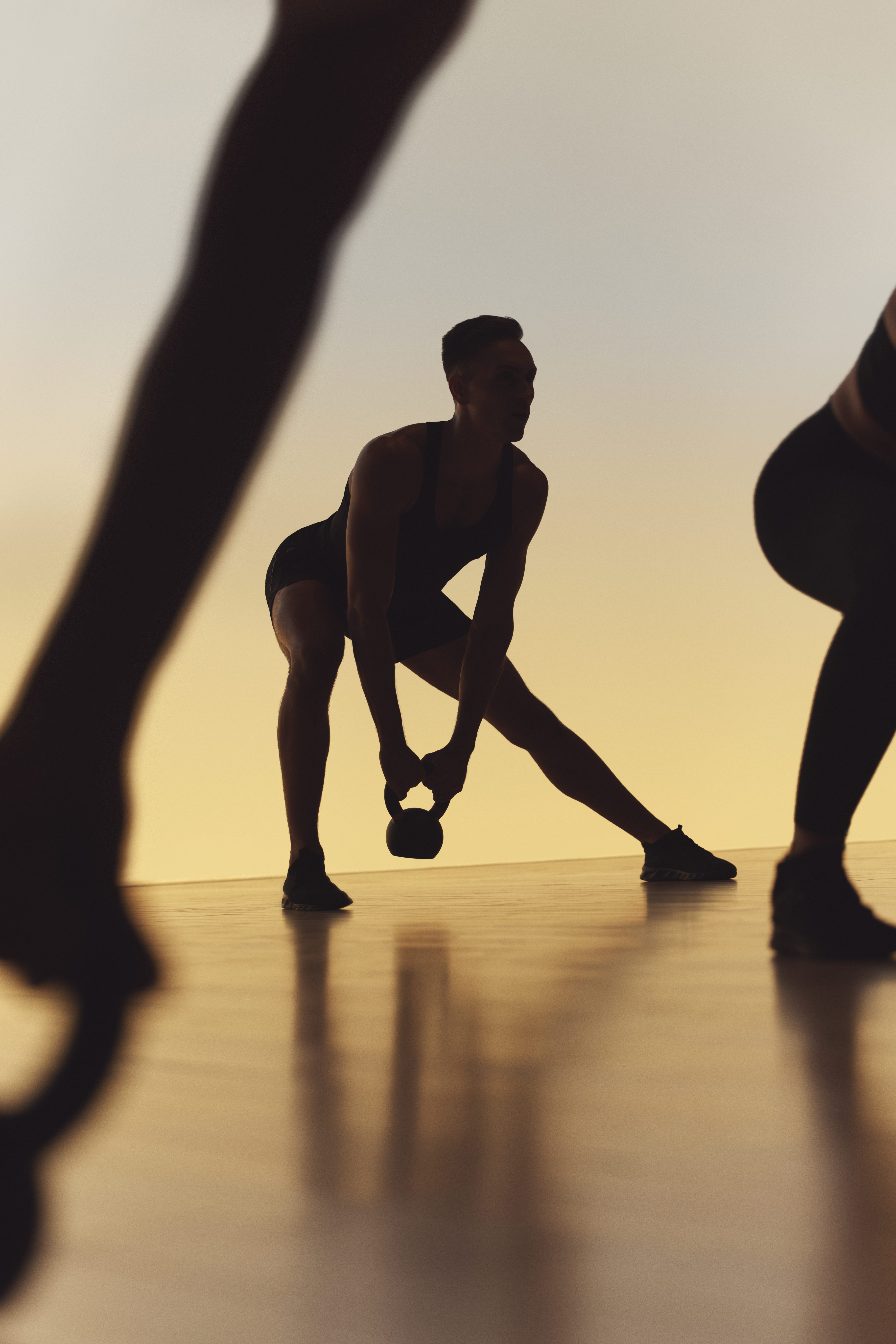 Xtreme cardio class members doing side lunges at Life Time