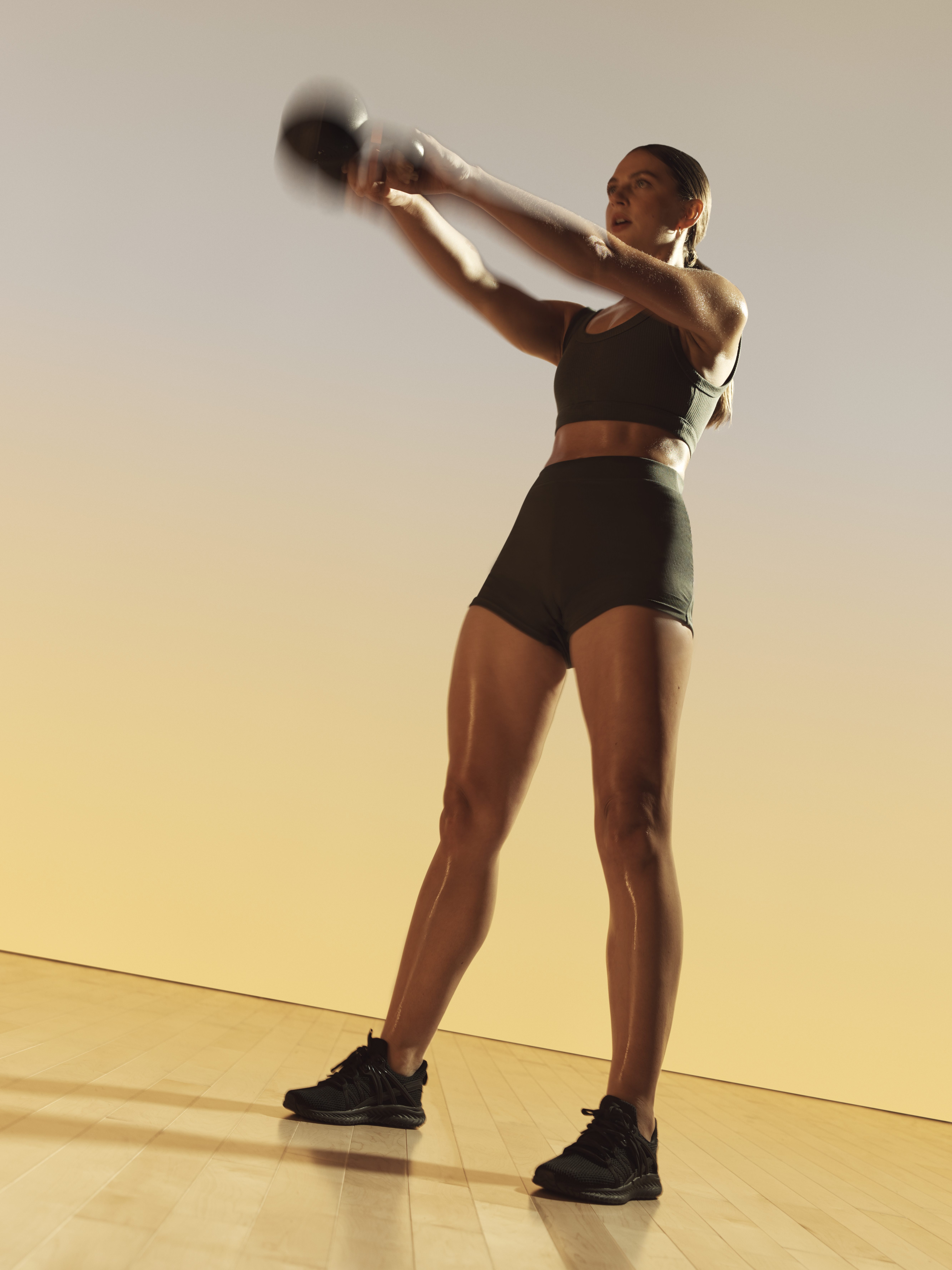 Xtreme cardio class member swinging a kettlebell at Life Time
