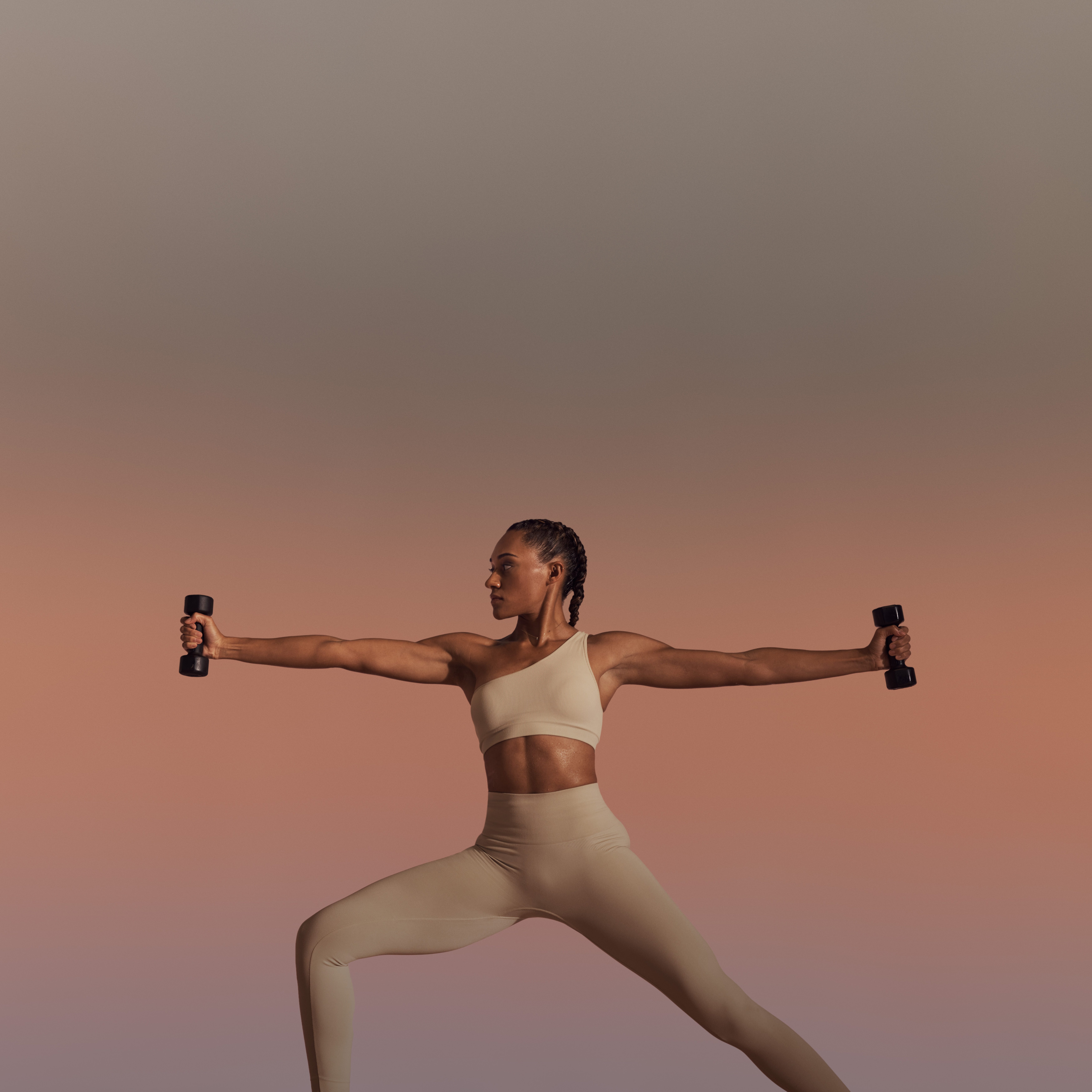 Life Time member using hand weights in warrior sculpt yoga class