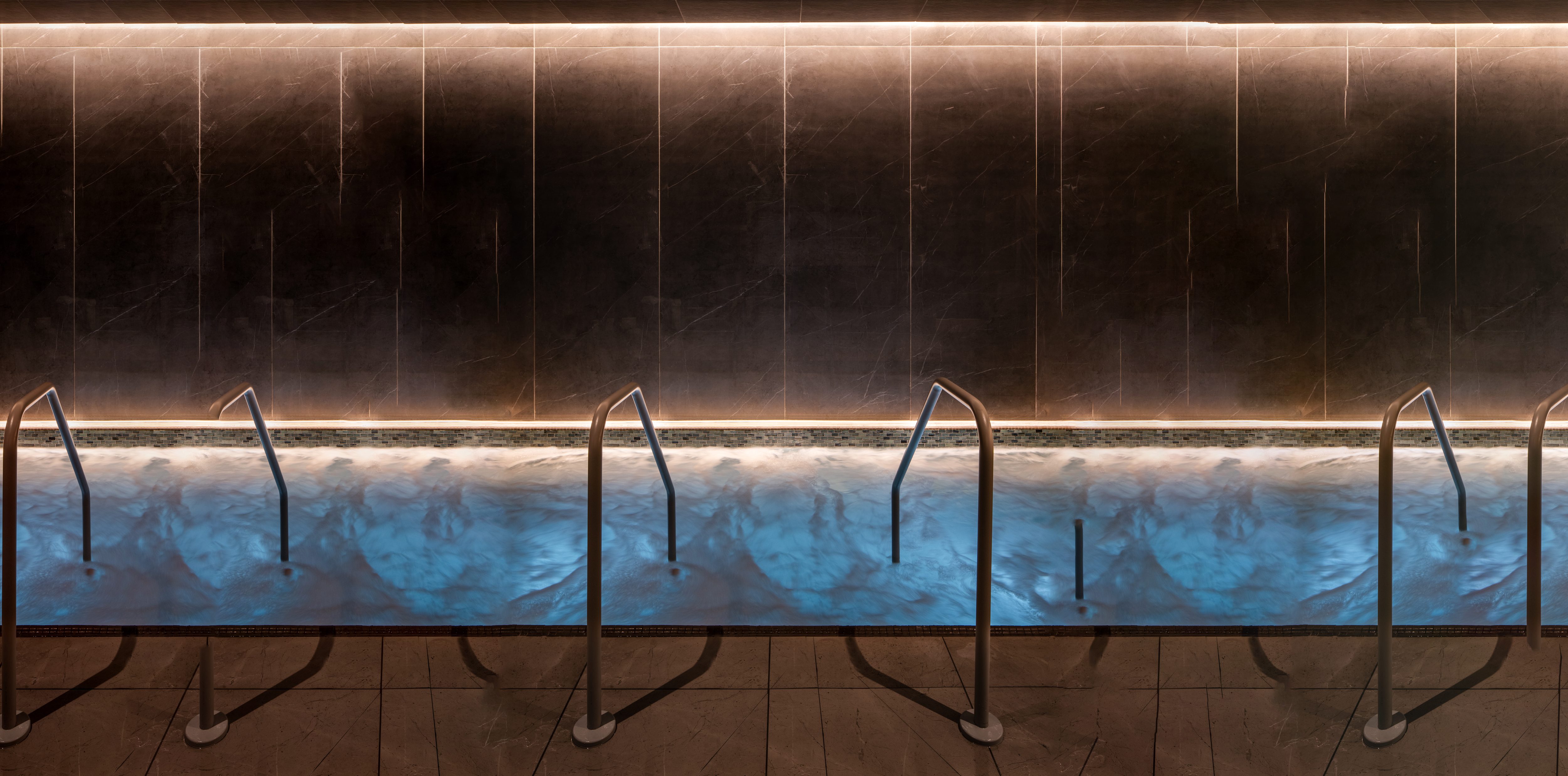 stairs leading into a dimly lit, bubbling whirlpool