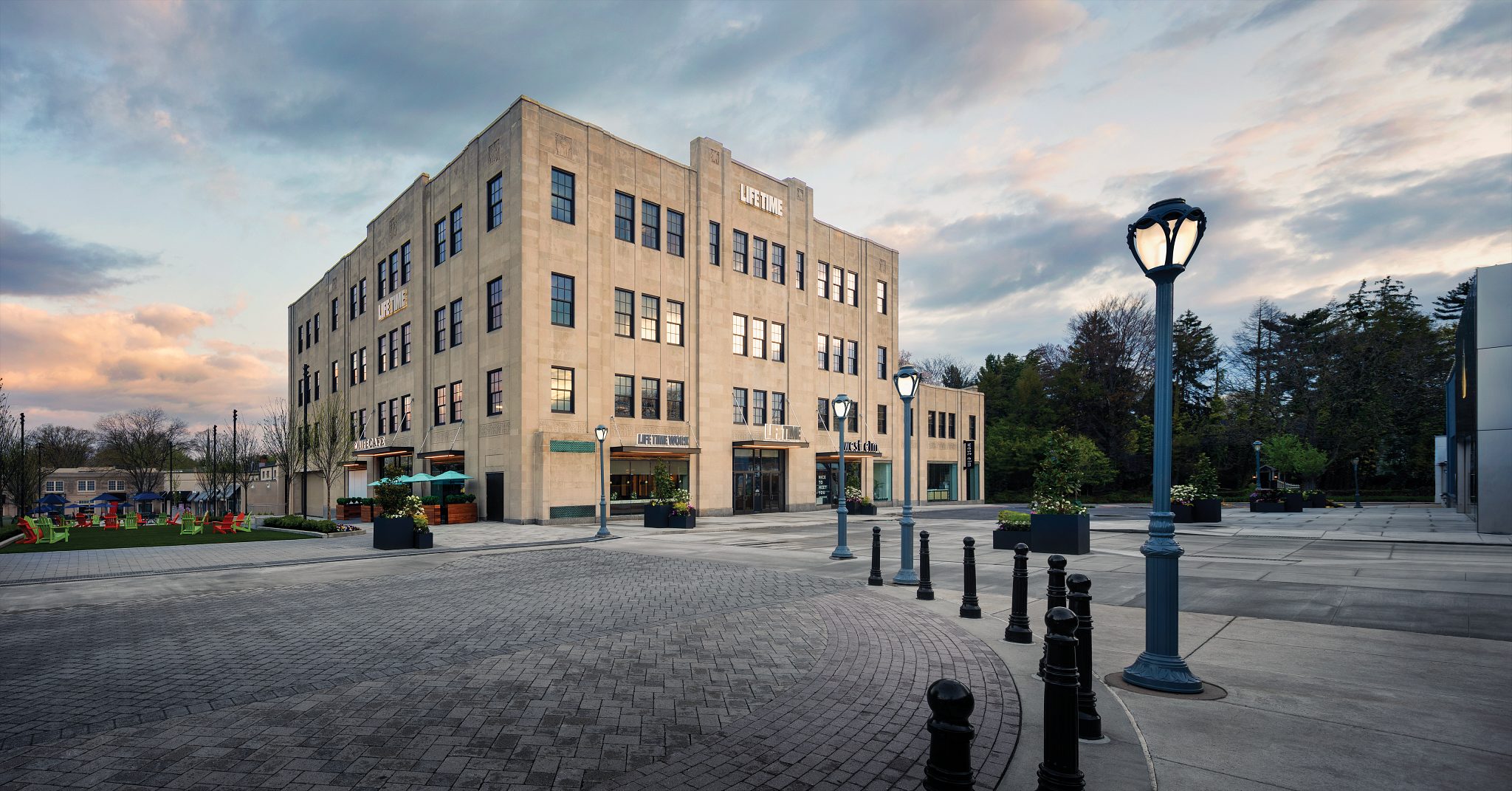 An exterior view of Life Time Ardmore and the surrounding area at dusk