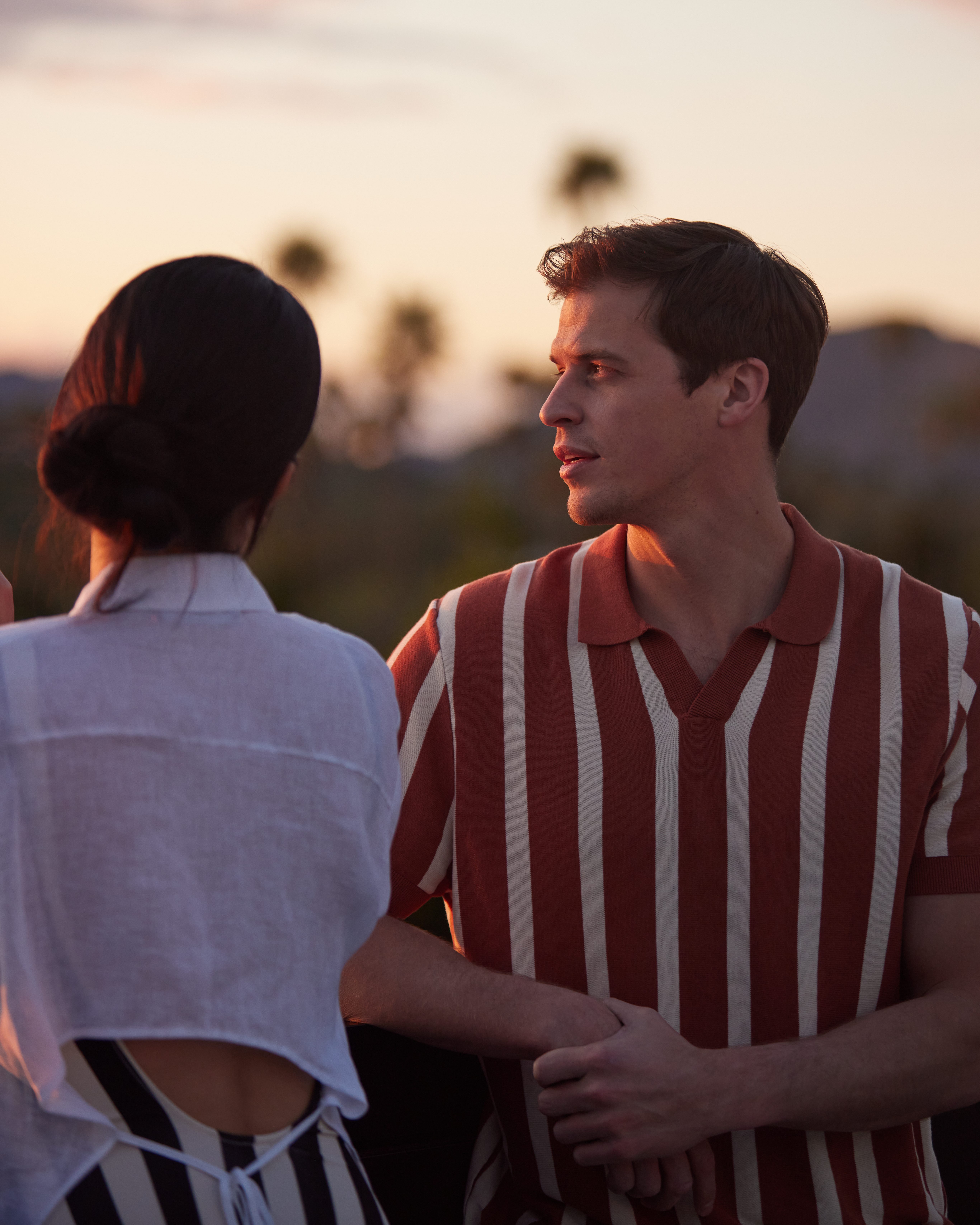 A couple standing together with mountains in the far distance