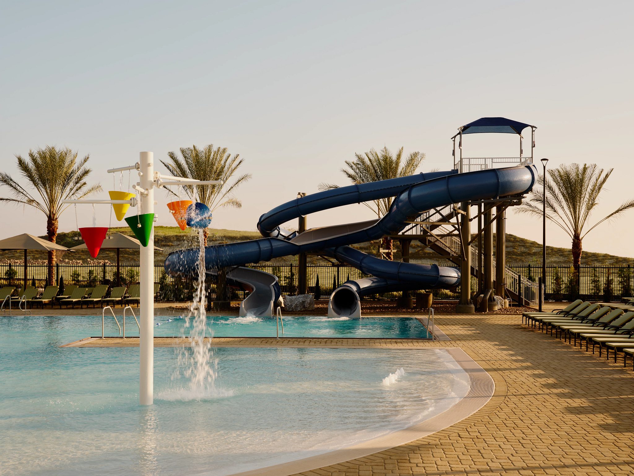 Outdoor waterslide and pool play area at the Life Time Otay Ranch club location