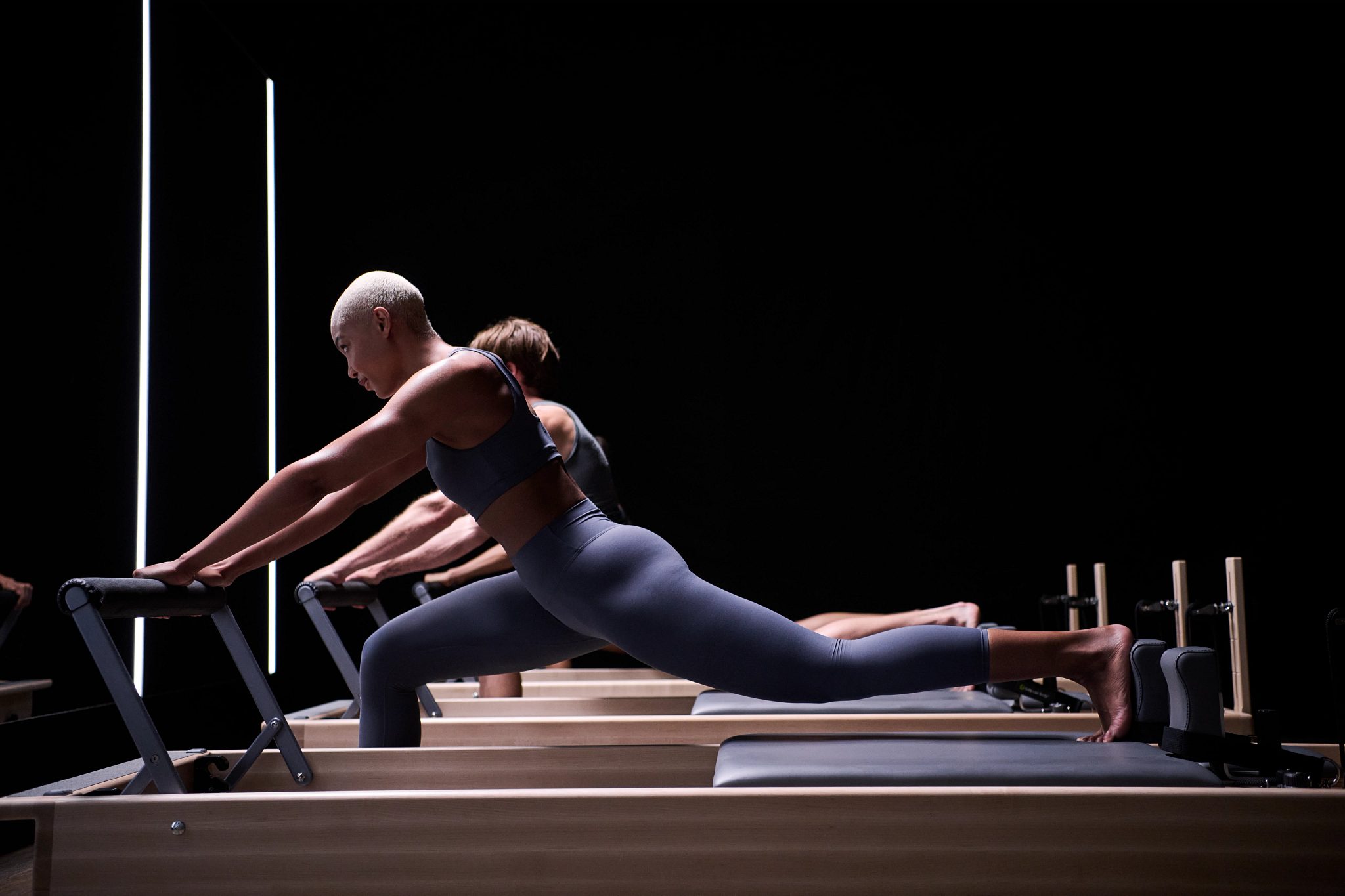 Participants on reformers during a CTR Pilates small group training session