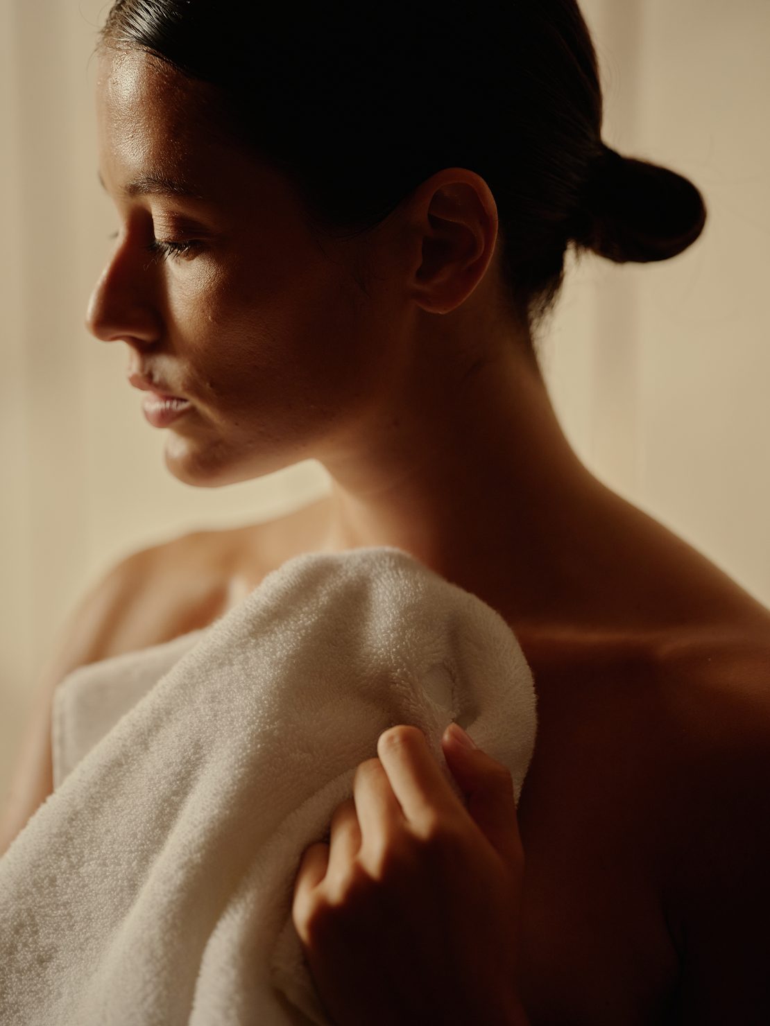 woman holding a towel up to her chest
