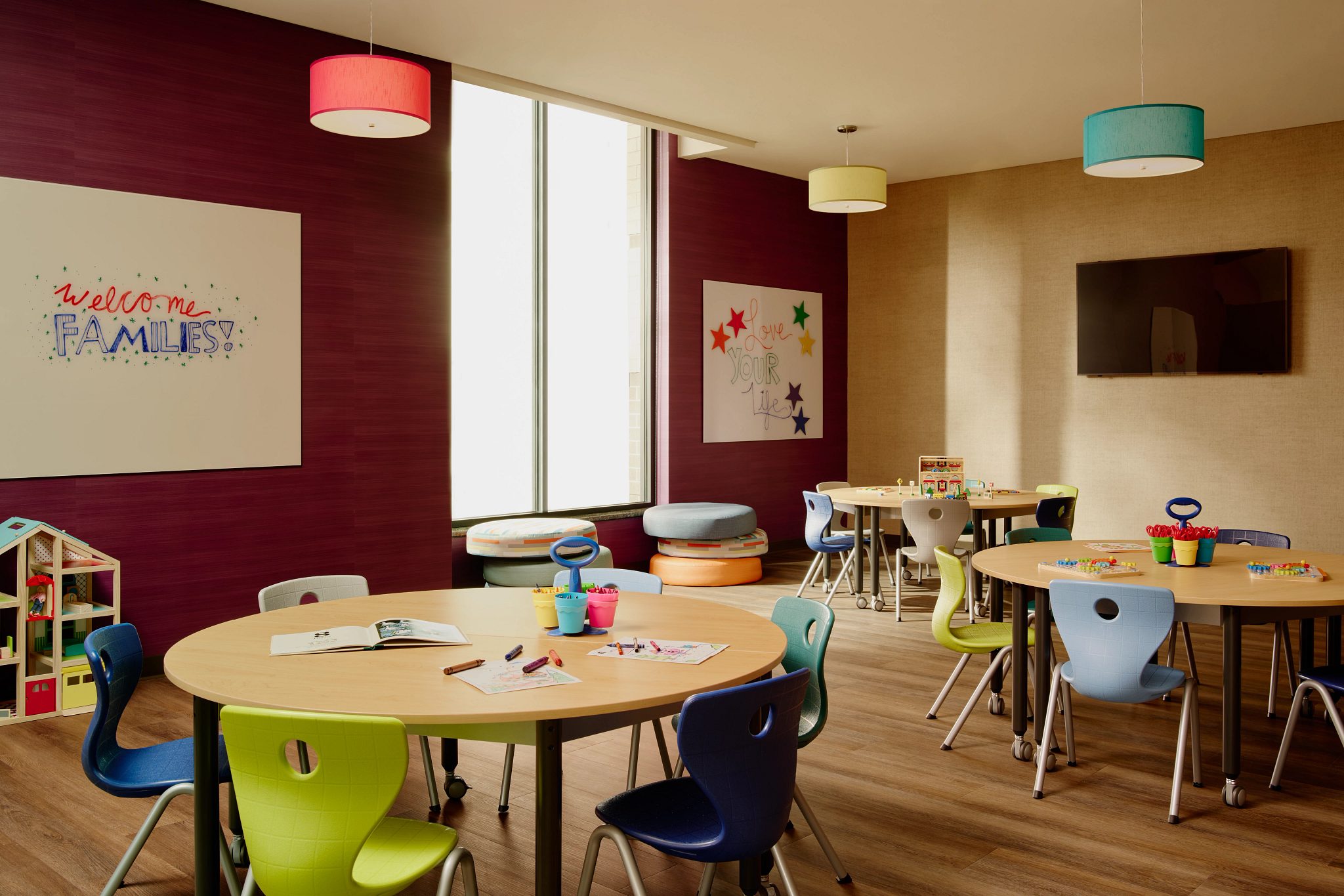 Otay Ranch Kids Academy colorful chairs and tables with crayons and papers on them.