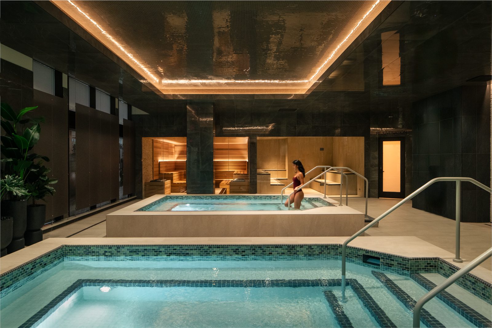 A woman walking into an indoor whirlpool
