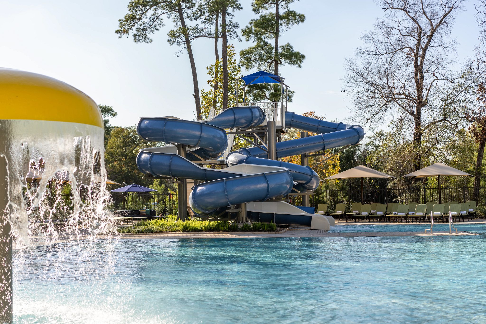 Outdoor pool area with waterslide at Life Time