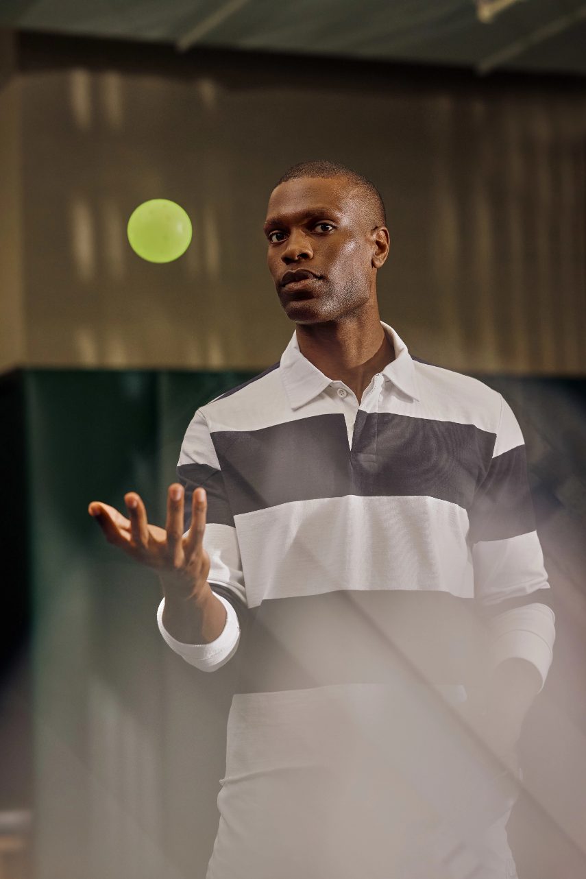 man throwing a pickleball in the air