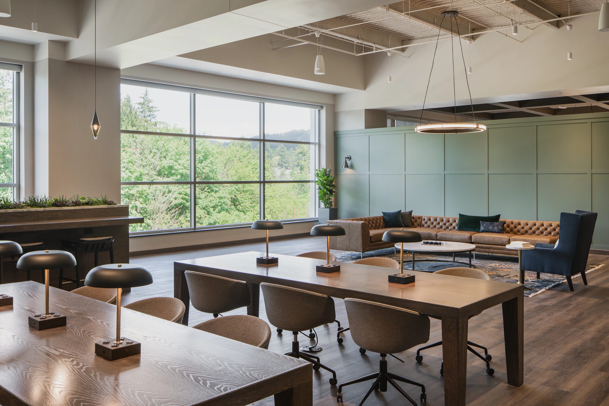 A warm coworking environment with desk areas and couch seating areas