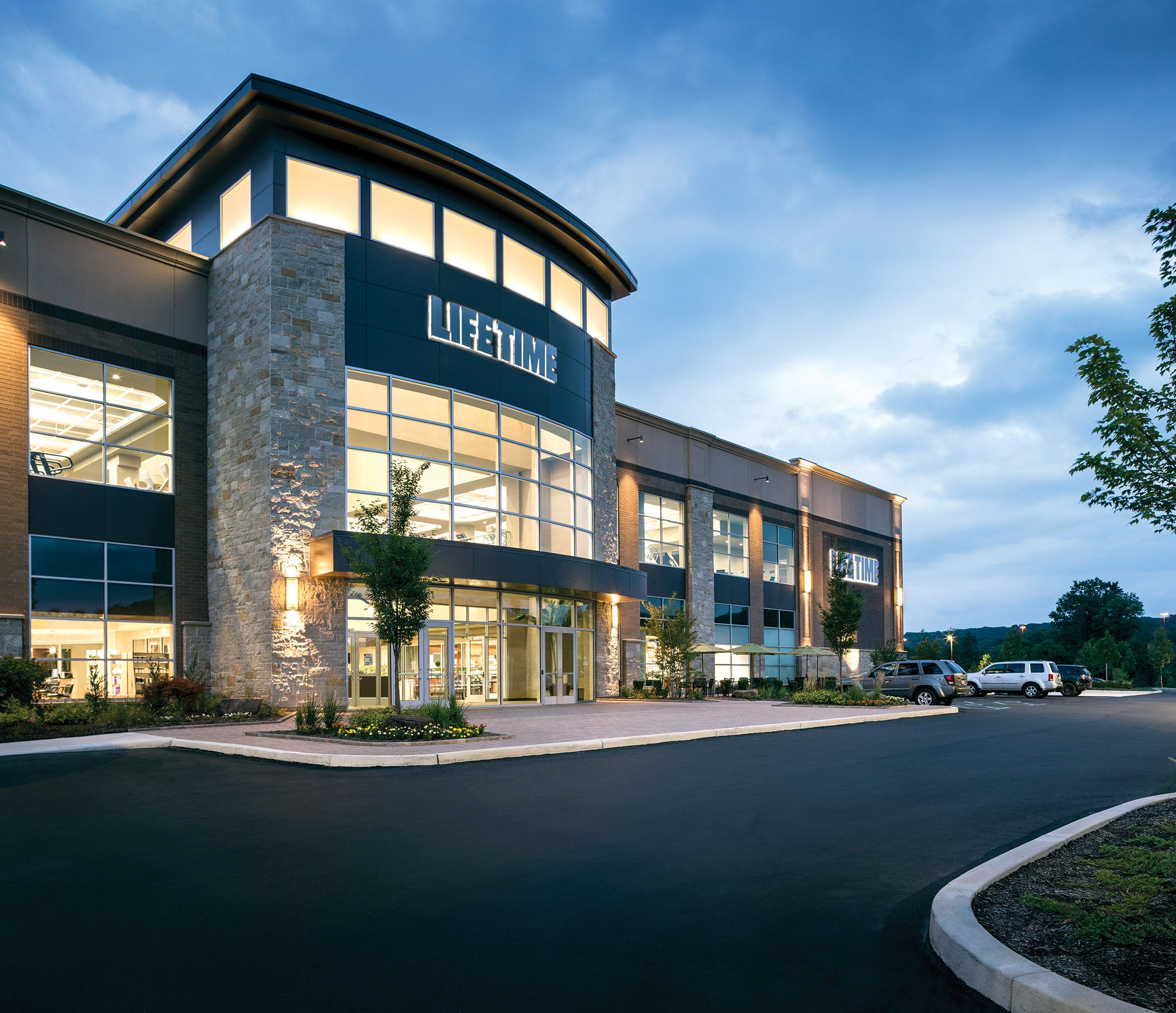 The exterior of a Life Time location at dusk