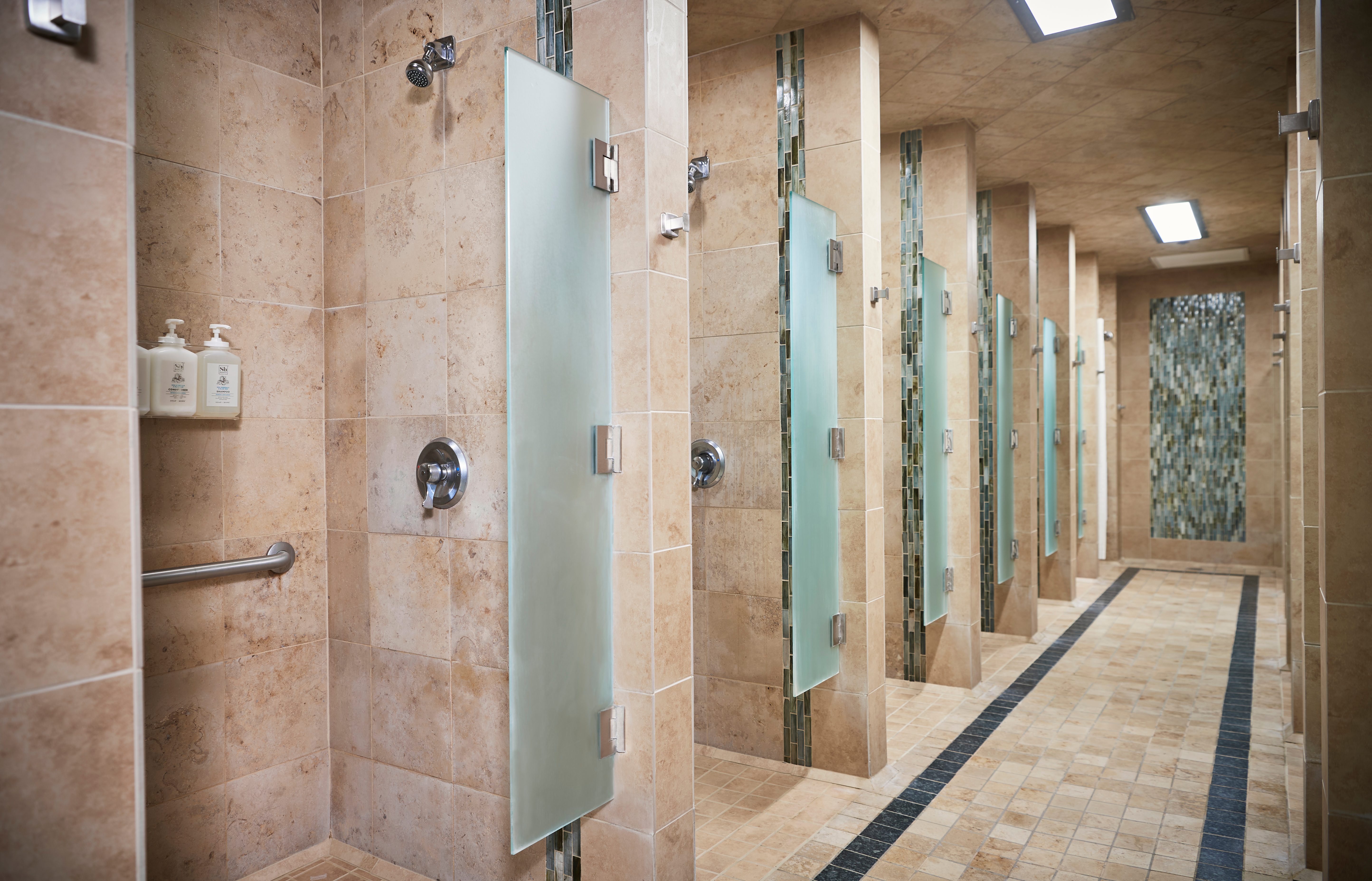 Row of shower stalls in a locker room at Life Time