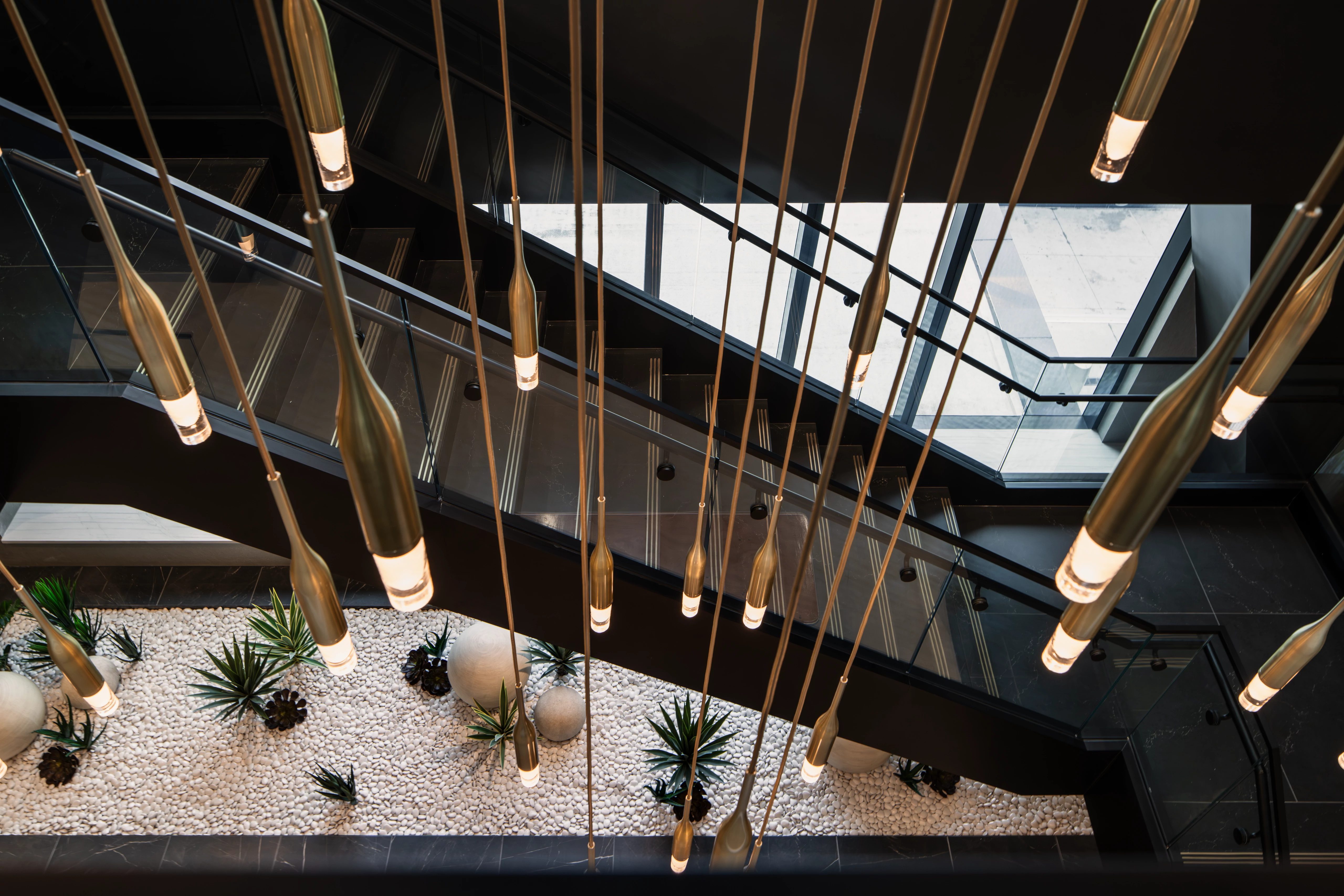 Top view of chandelier above a staircase at the Life Time Atlantic Avenue club location