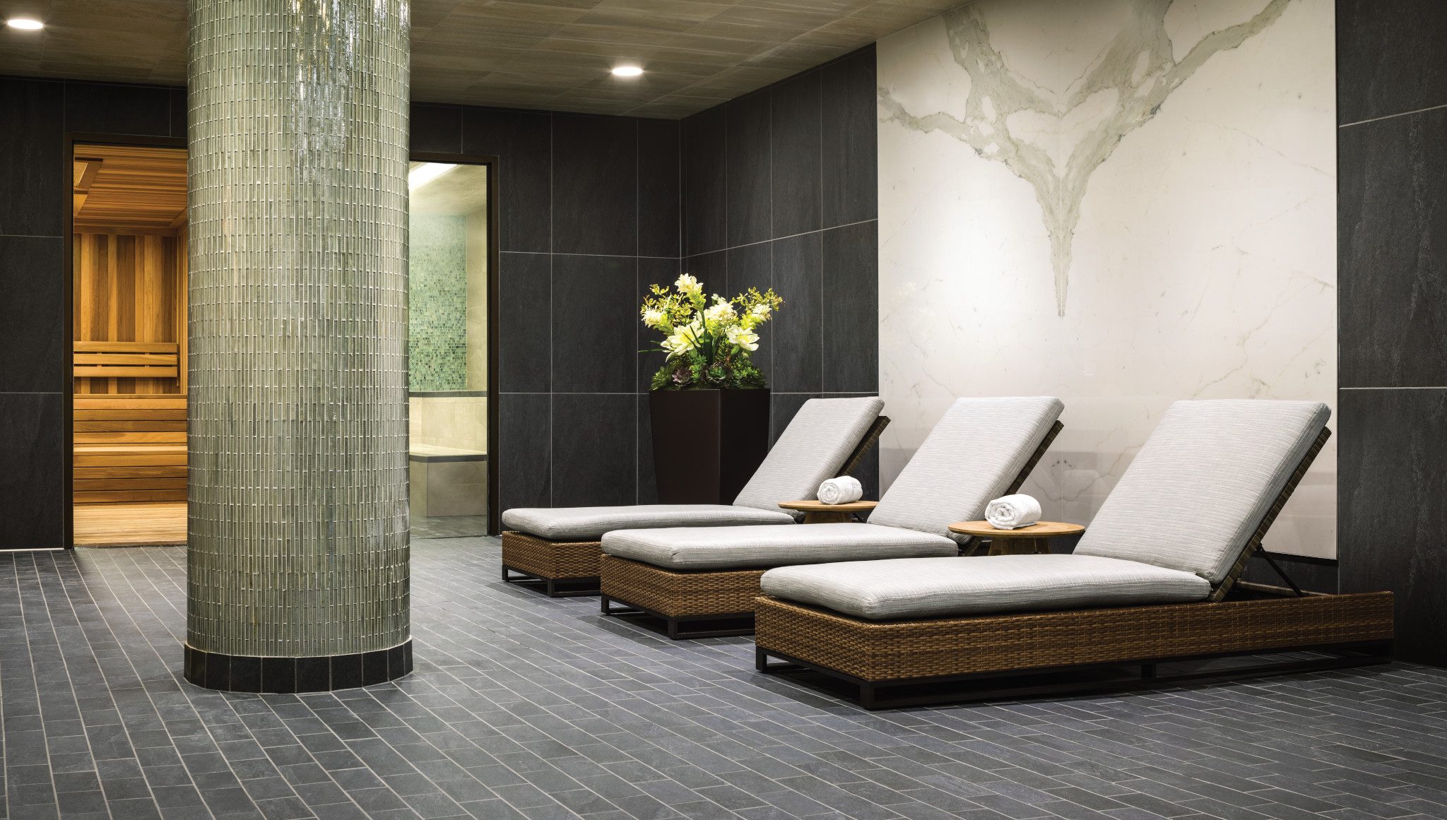 Lounge chairs next to an indoor whirlpool