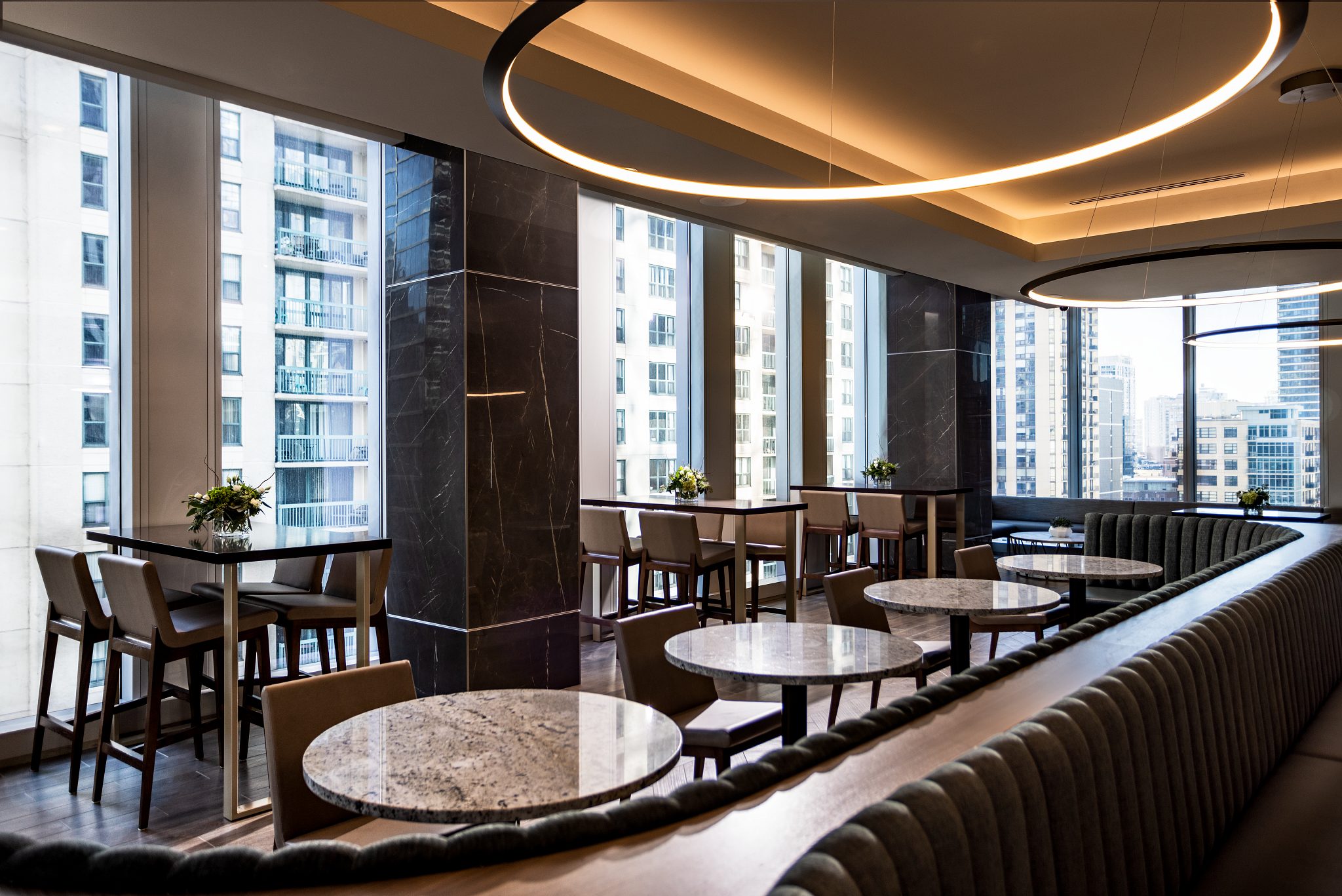 Tables, chairs, and booths in a warm dining environment