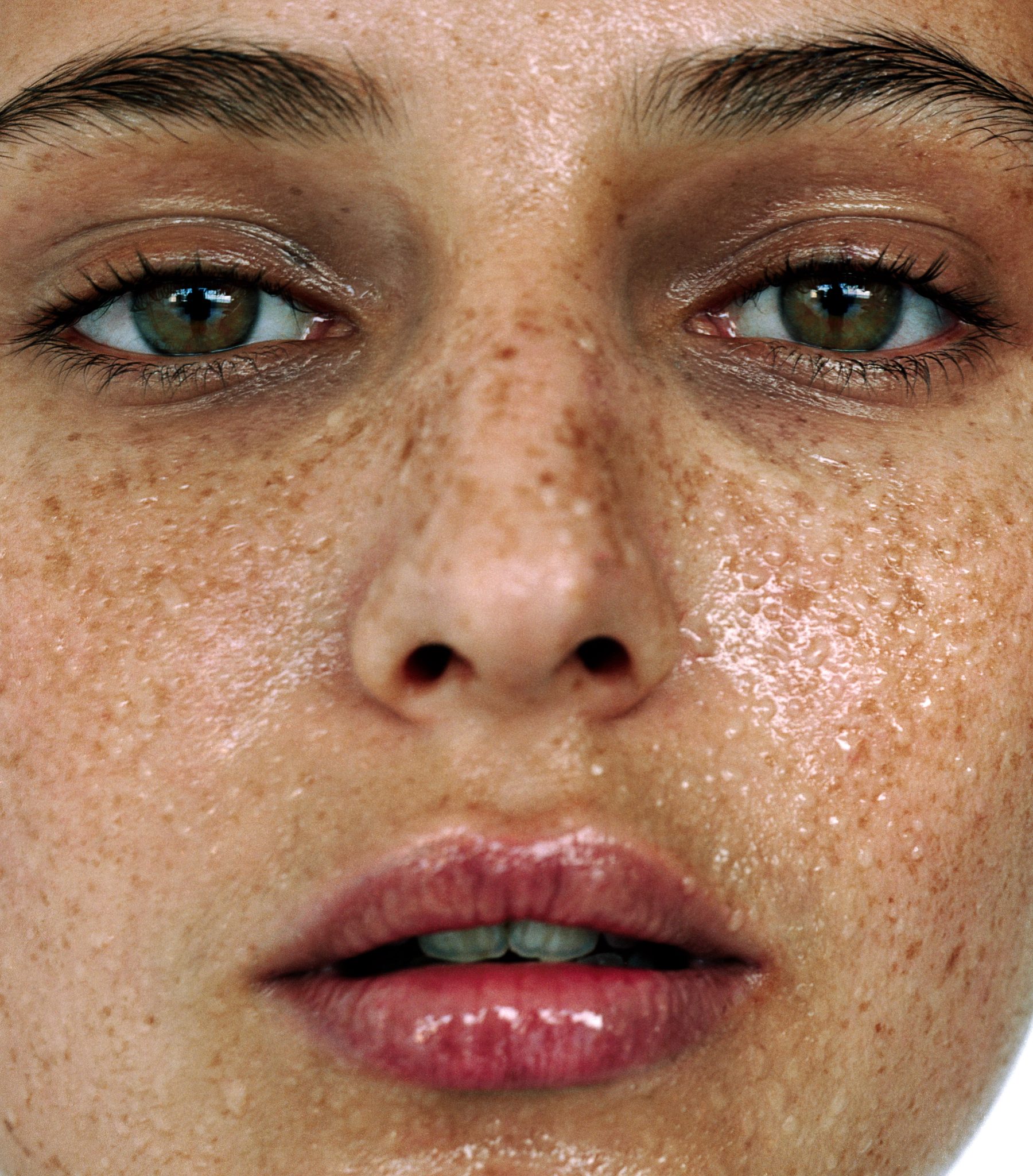 Closeup of a females face drenched with sweat