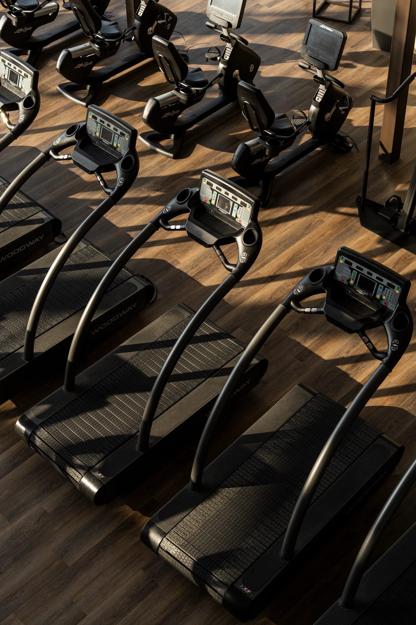 Overhead view treadmills lined up on a fitness floor at Life Time