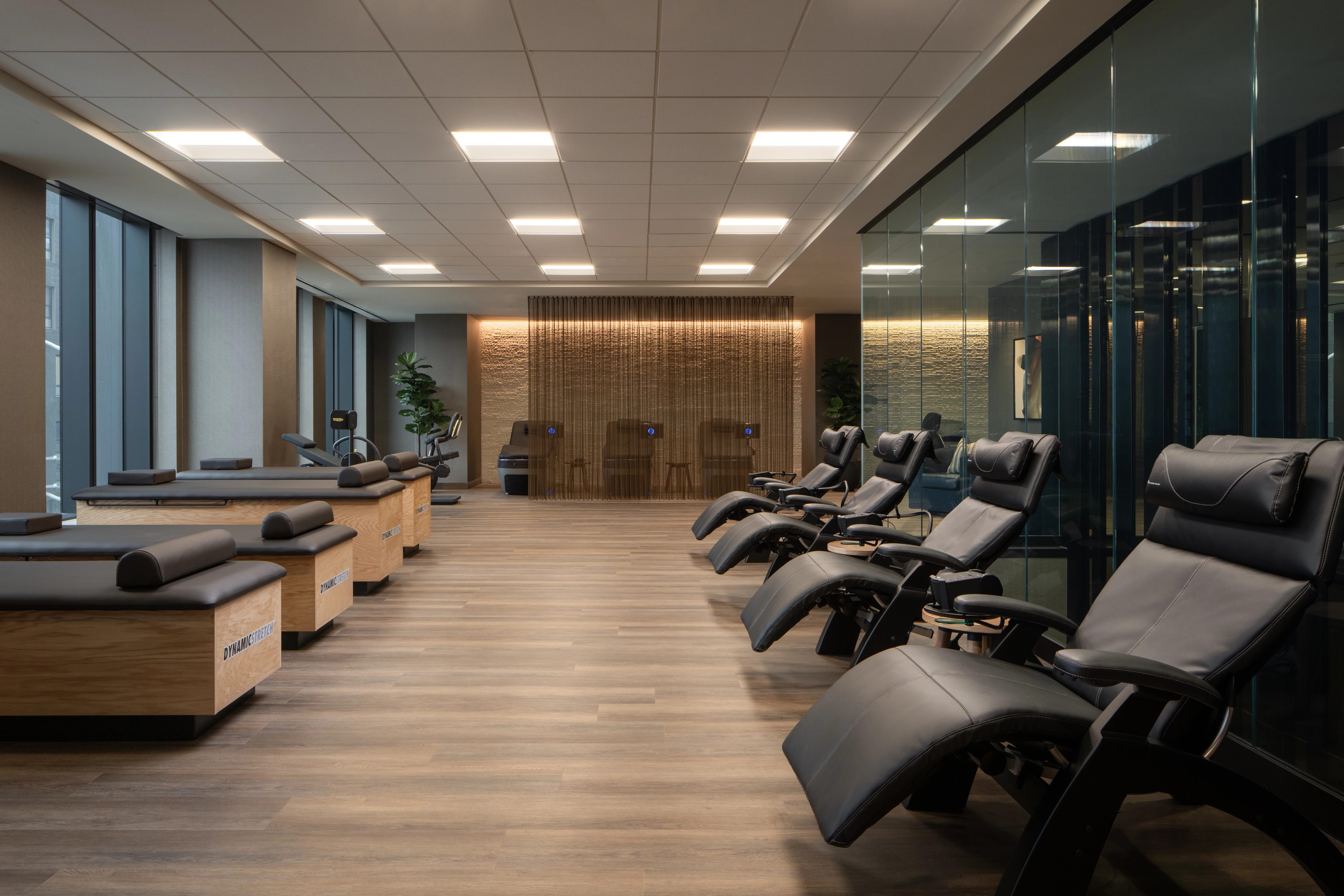 Dynamic Stretch tables and chairs lined up in the recovery area at Life Time
