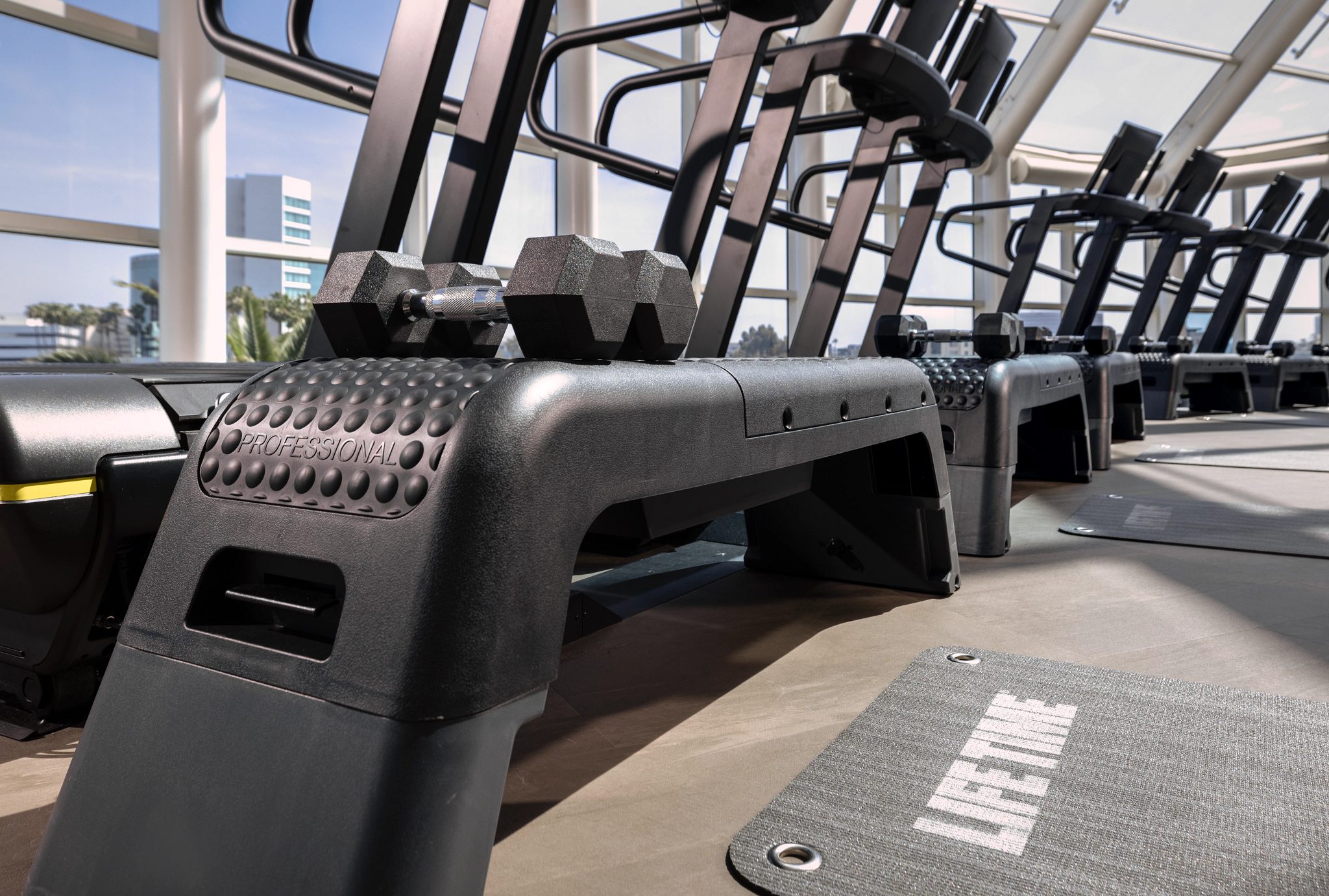 Treadmills and steps on the fitness floor at Life Time