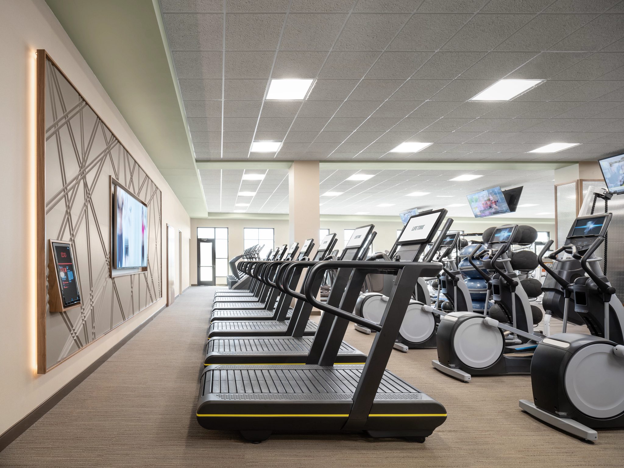 View of treadmills and stairclimbers lined up on the fitness floor in the Rancho SanClemente Life Time location.