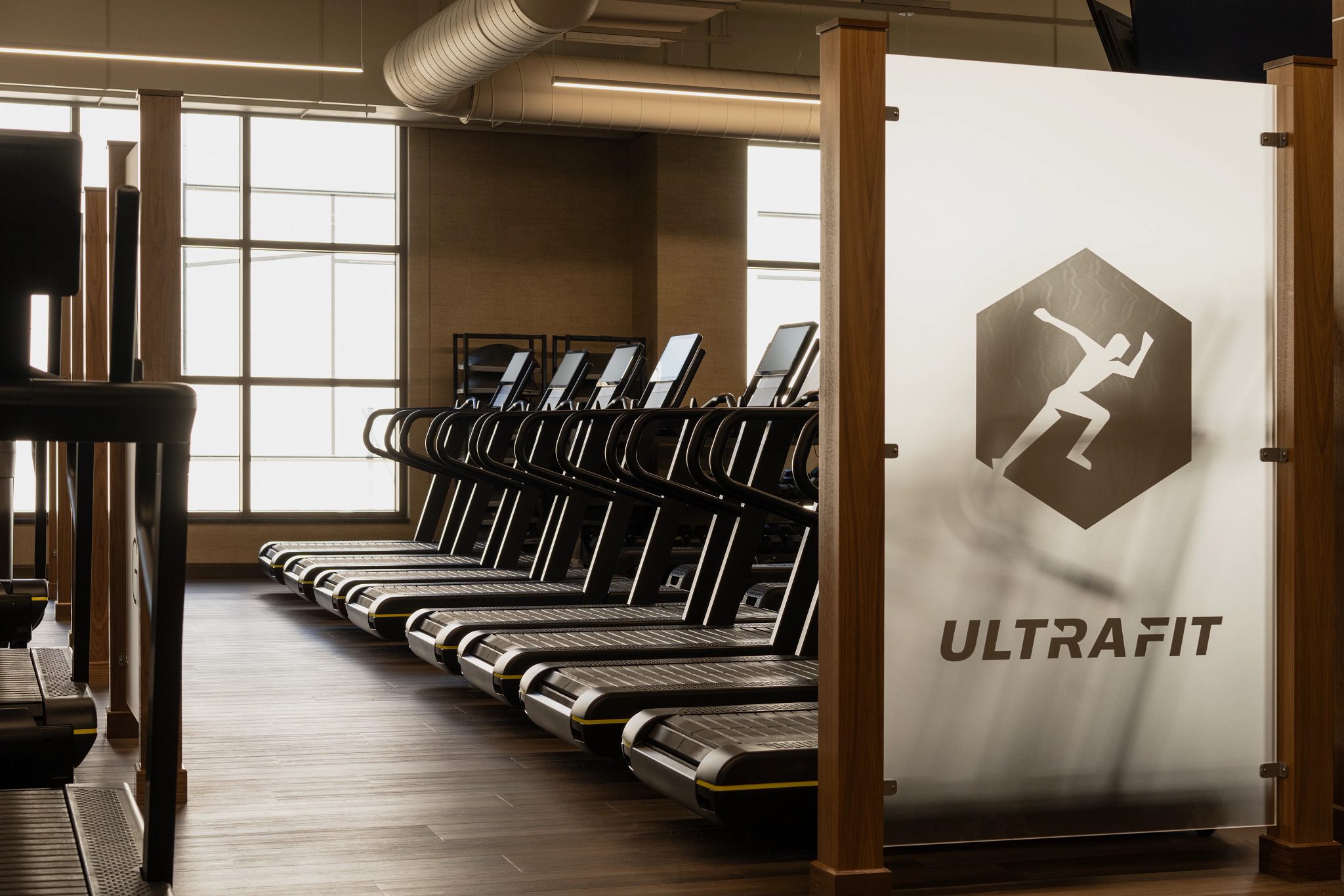 Treadmills lined up in the small group training area at the Life Time Walnut Creek club location