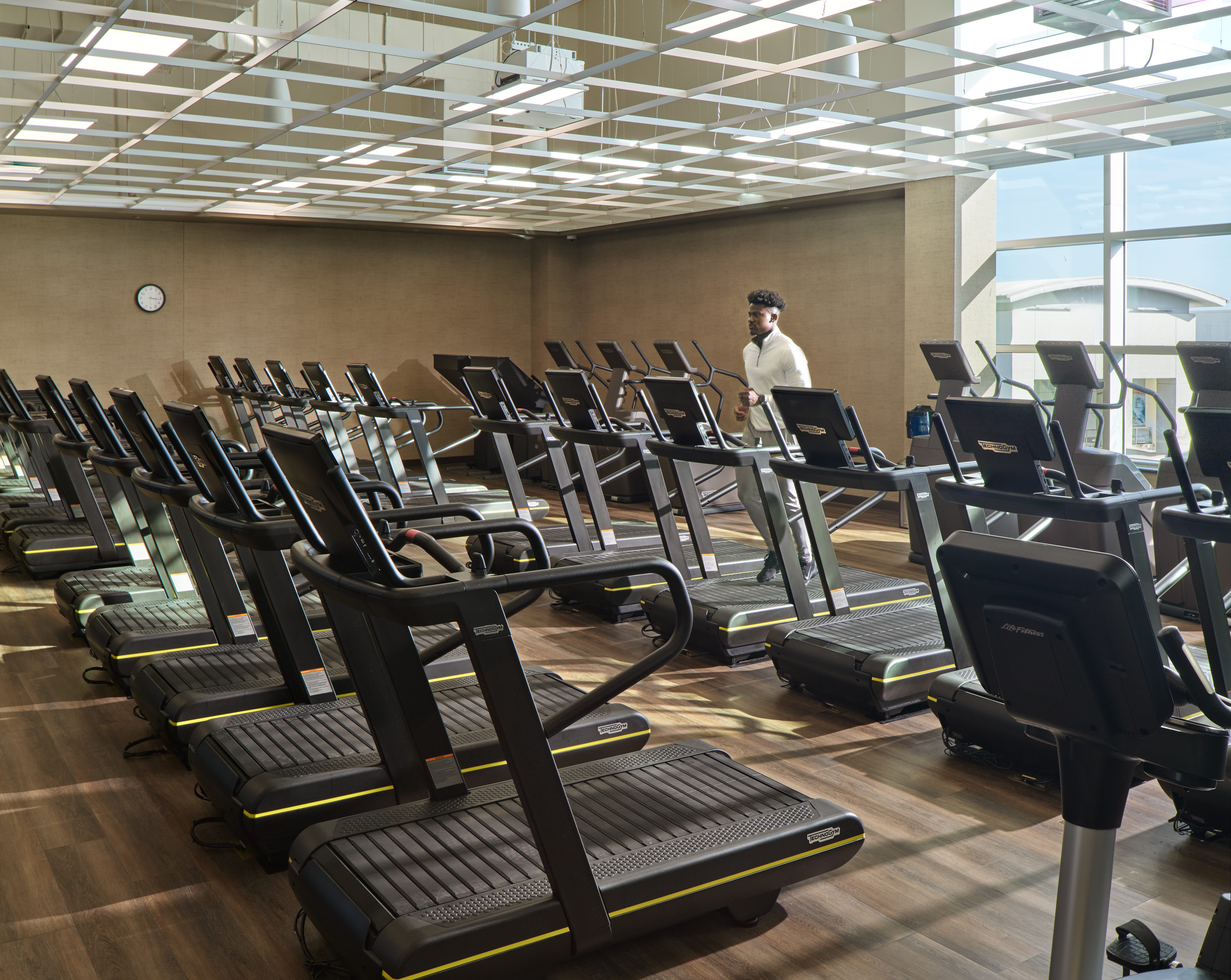 An adult male running on a treadmill