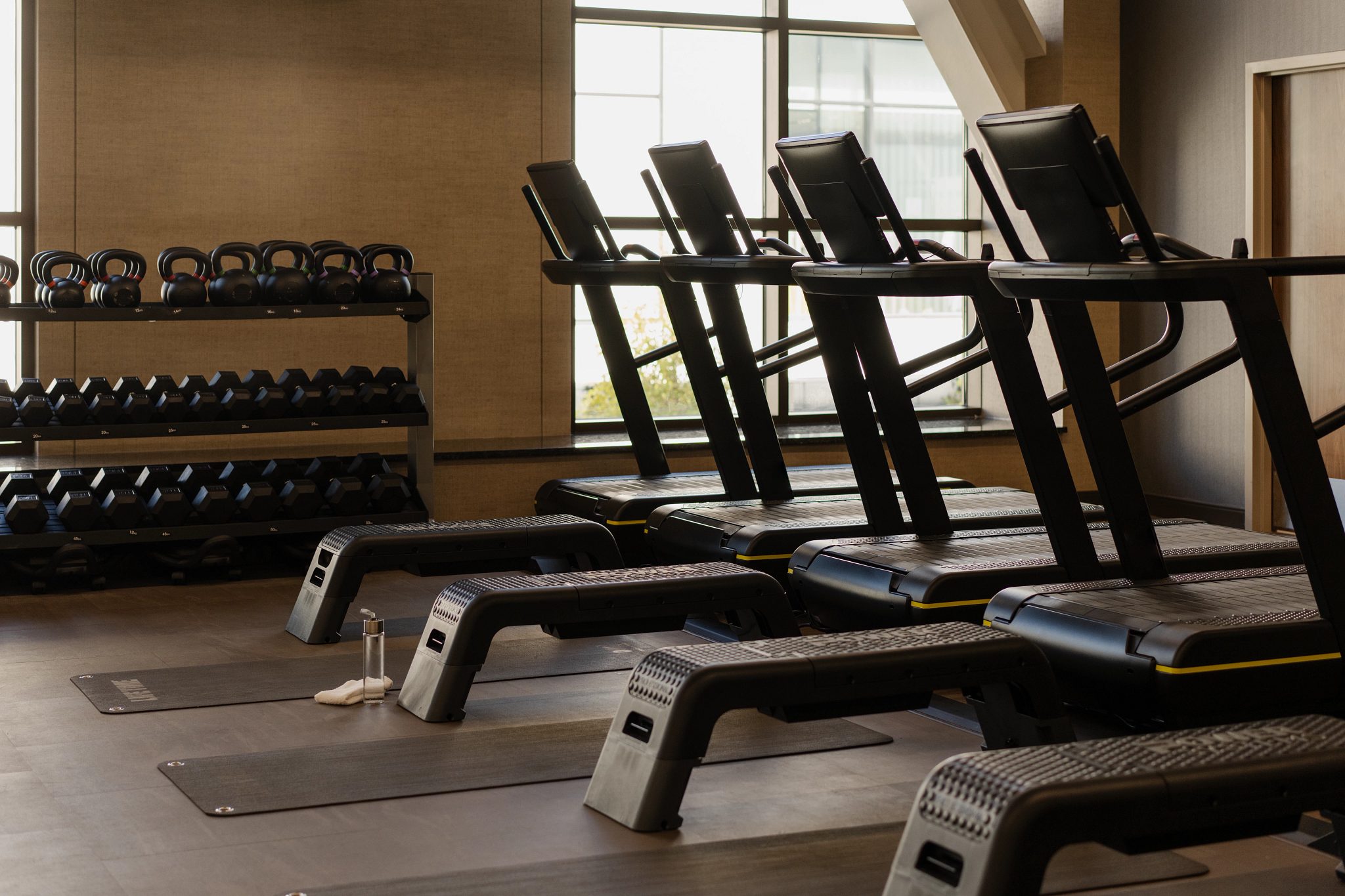 Line of treadmills in the small group training area on the fitness floor