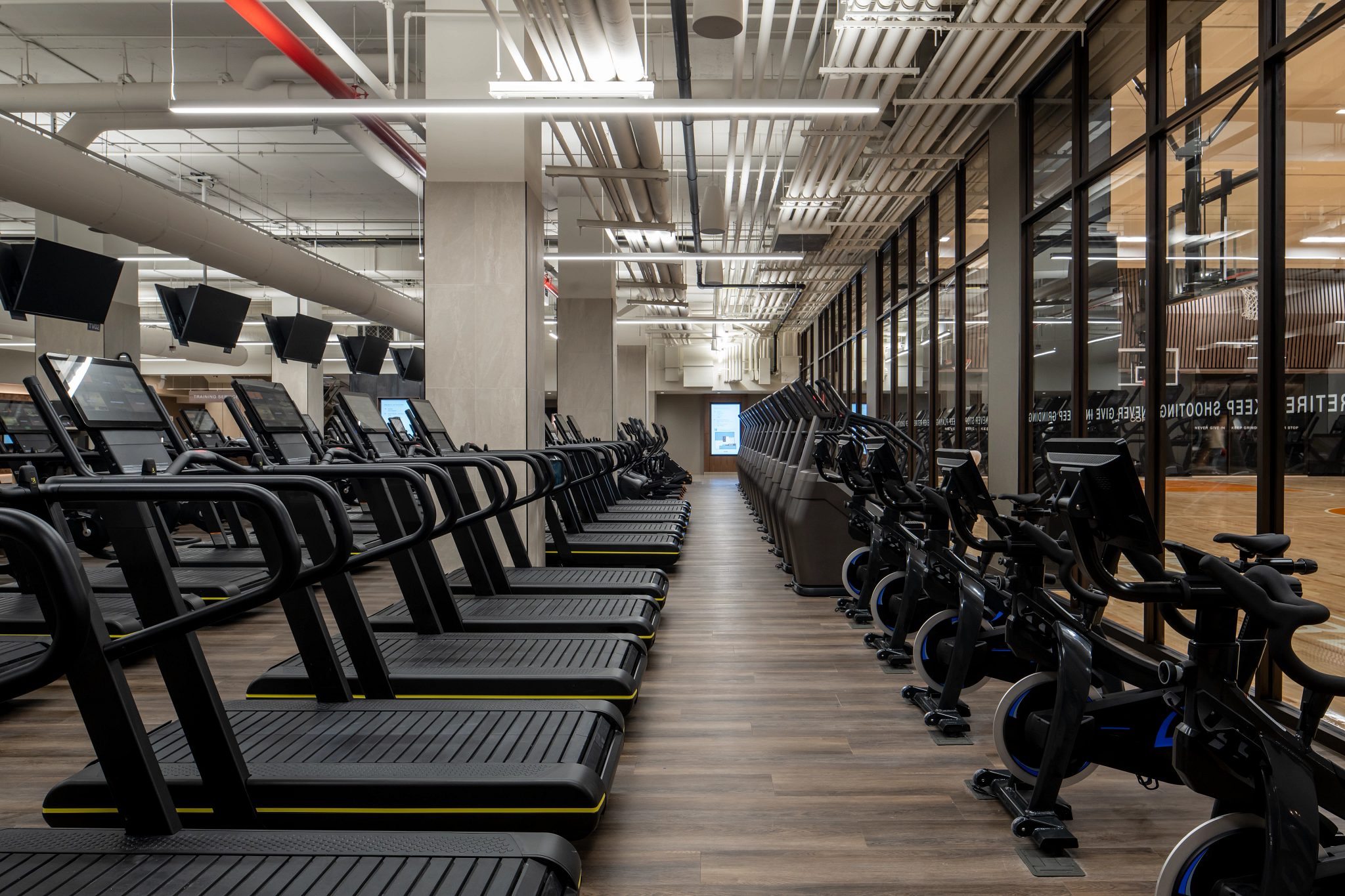 Stationary bikes, treadmills and stairclimbers on the fitness floor at the Life Time Dumbo club location