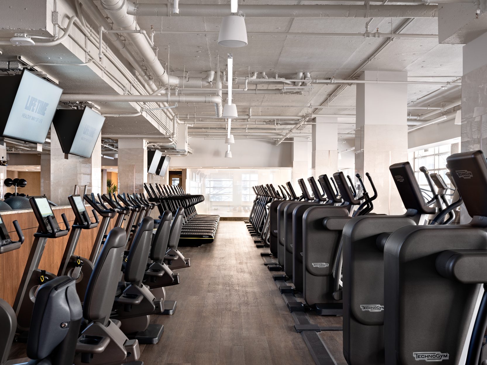 Cardio equipment on the fitness floor at Life Time