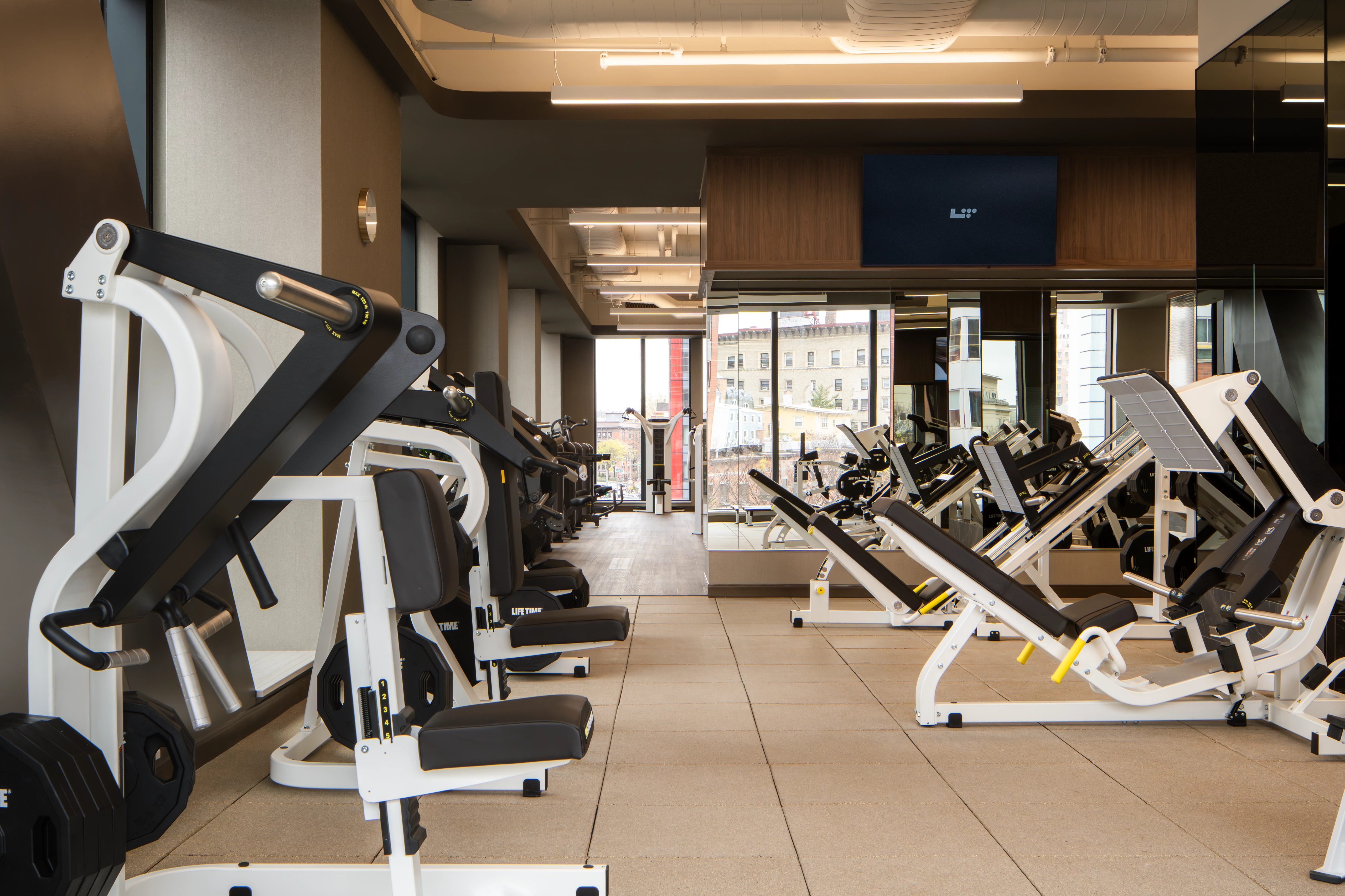 Strength training equipment on the fitness floor at the Life Time Atlantic Avenue club location
