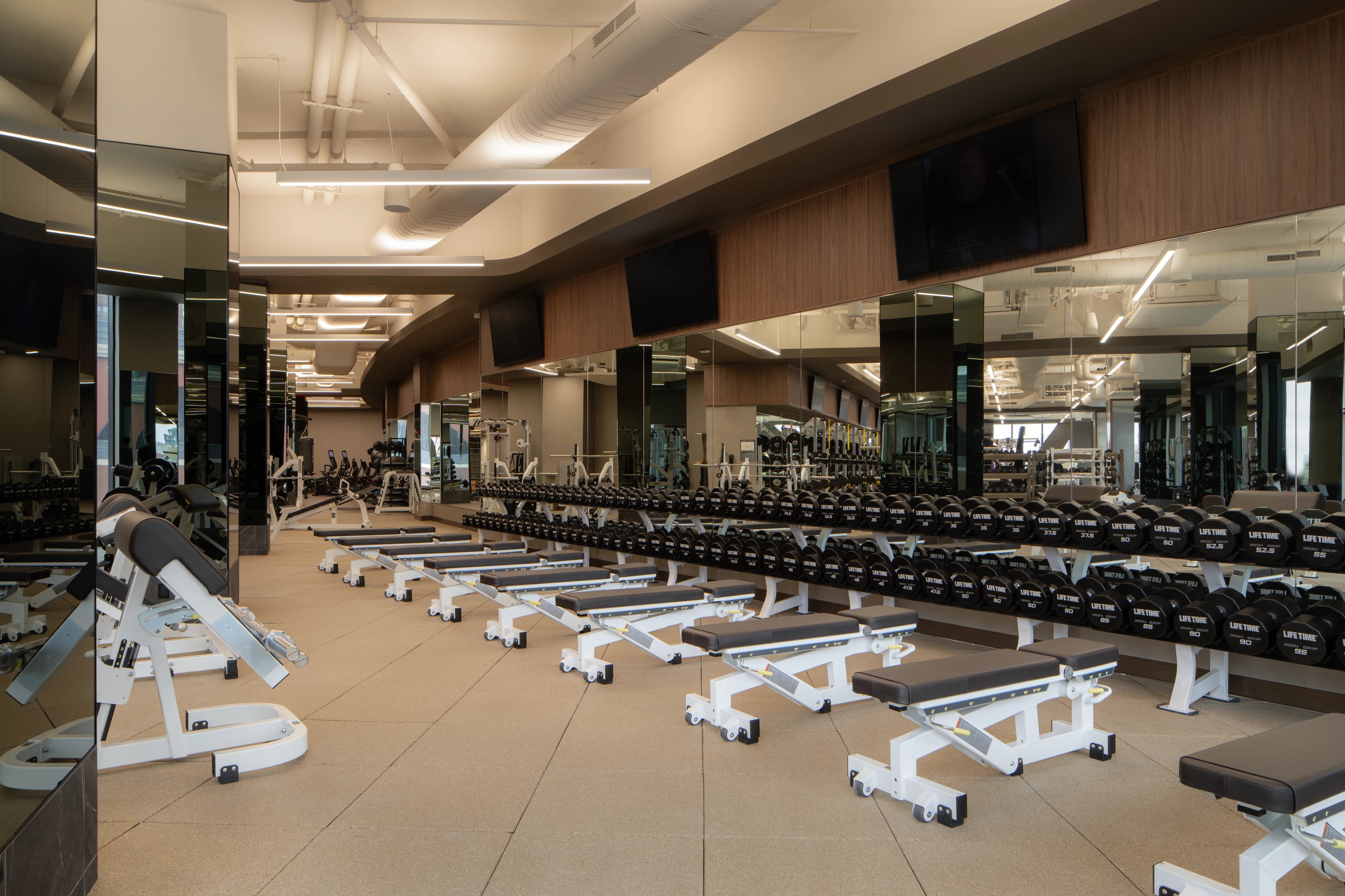 Strength training equipment on the fitness floor at the Life Time Atlantic Avenue club location