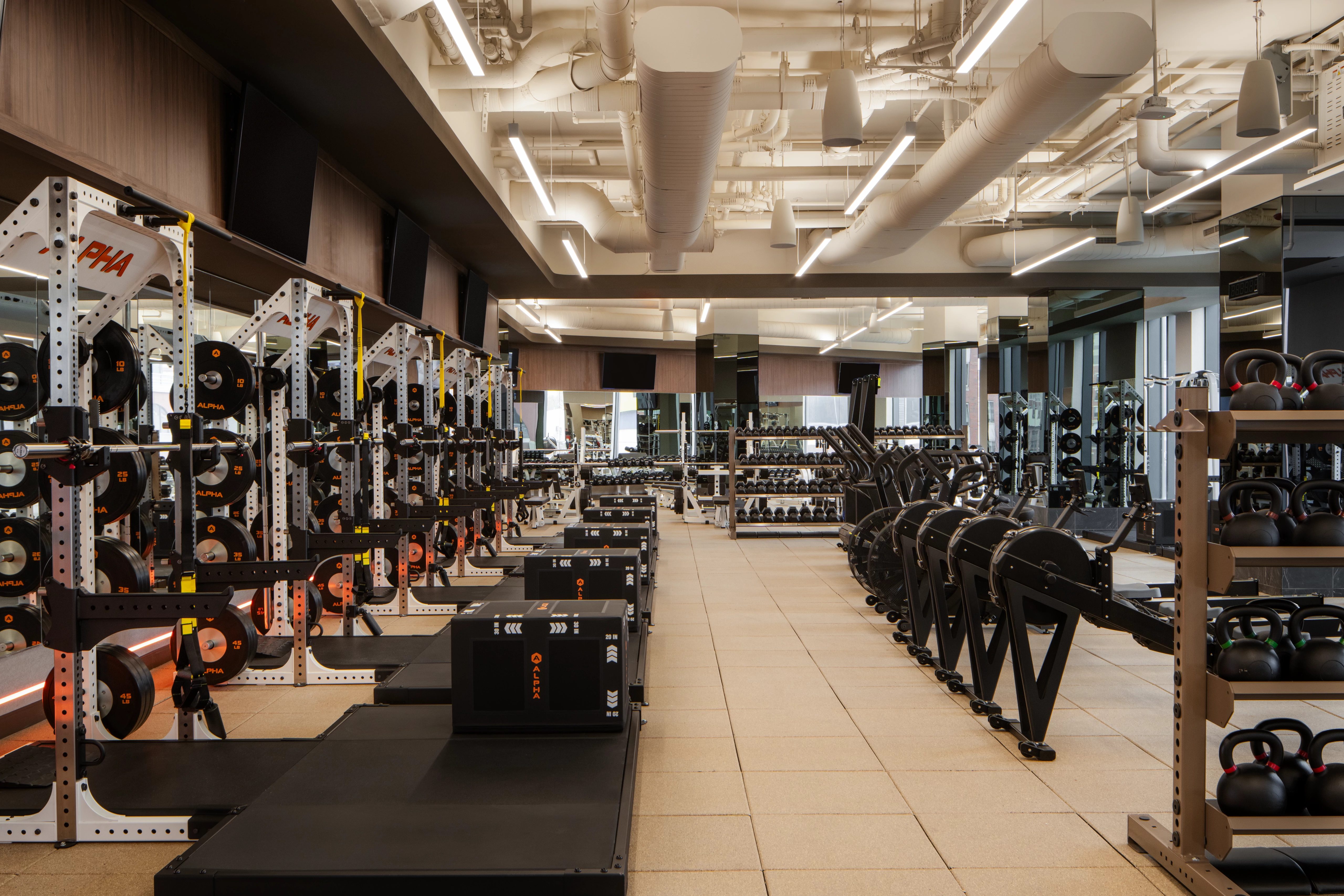 Strength training equipment on the fitness floor at the Life Time Atlantic Avenue club location