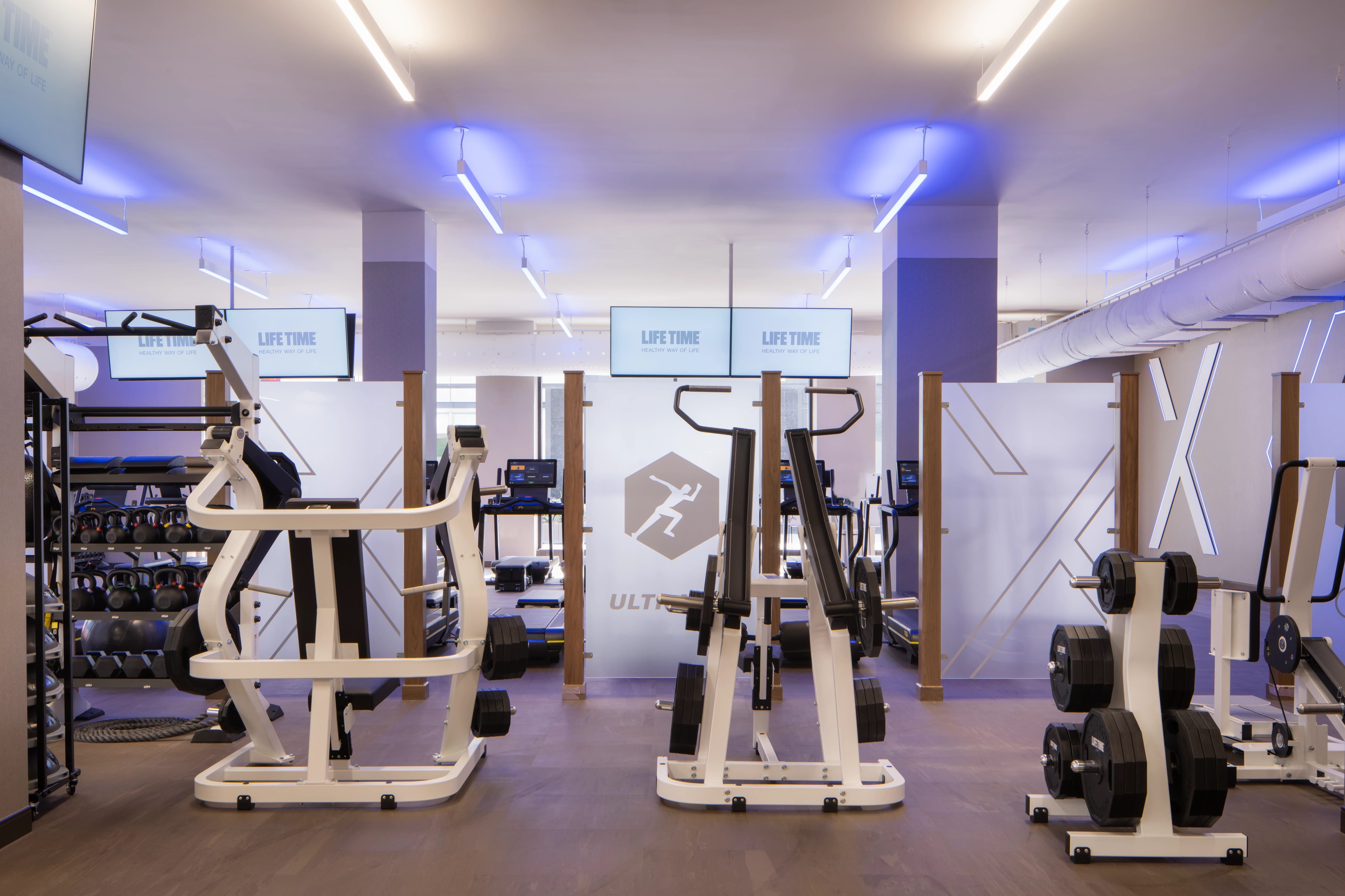 Strength training equipment on the fitness floor at Life Time