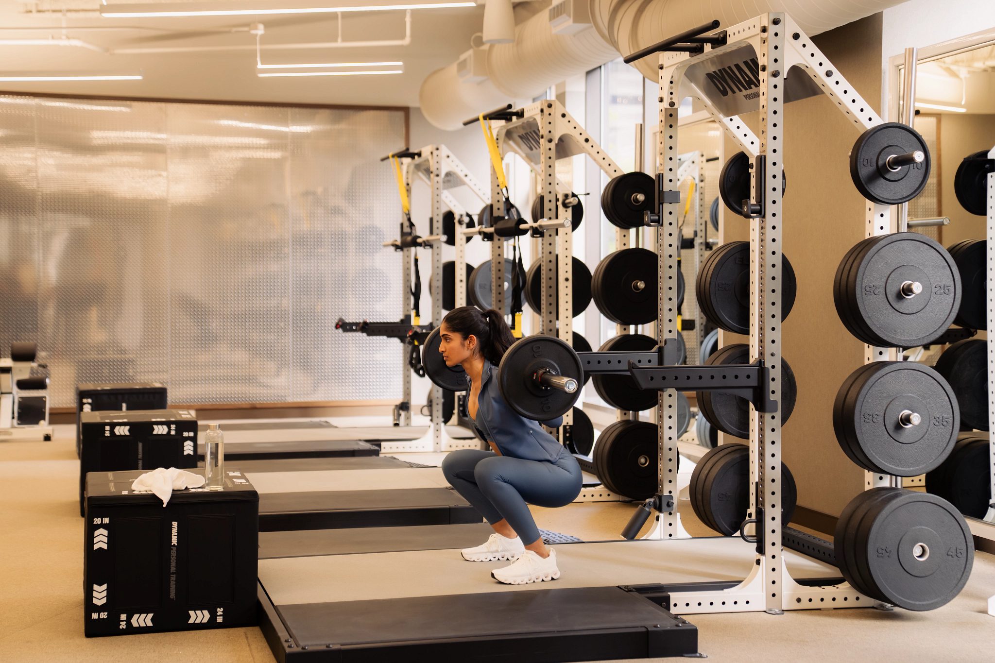 a woman lifting weights at Life Time