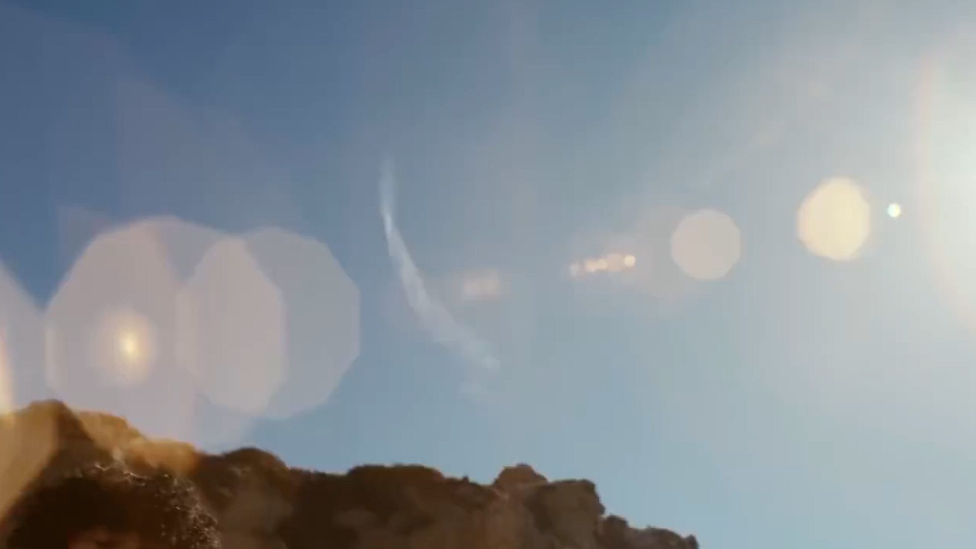 mountains and sun reflection in the sky