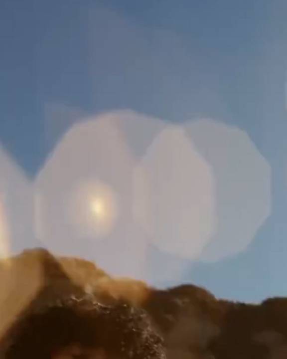 mountains and sun reflection in the sky