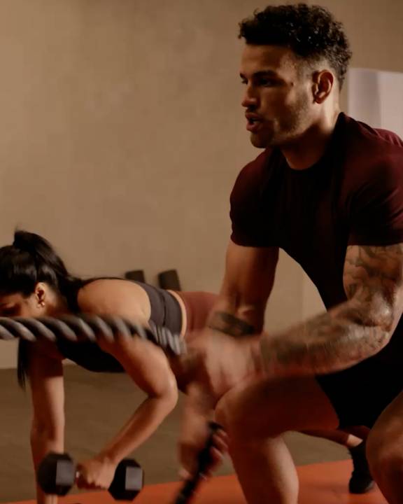 man working out with ropes