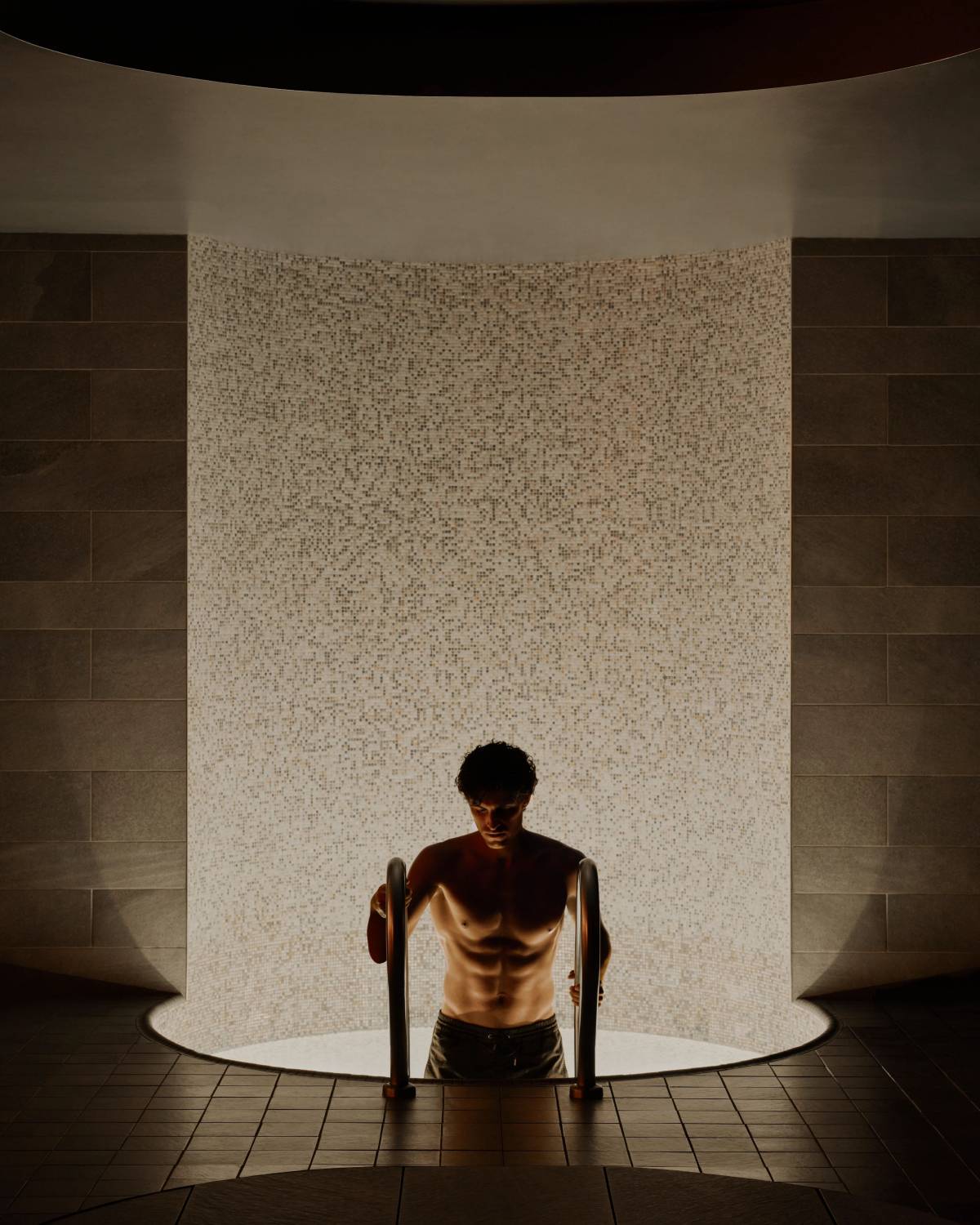 man climbing out of a cold plunge