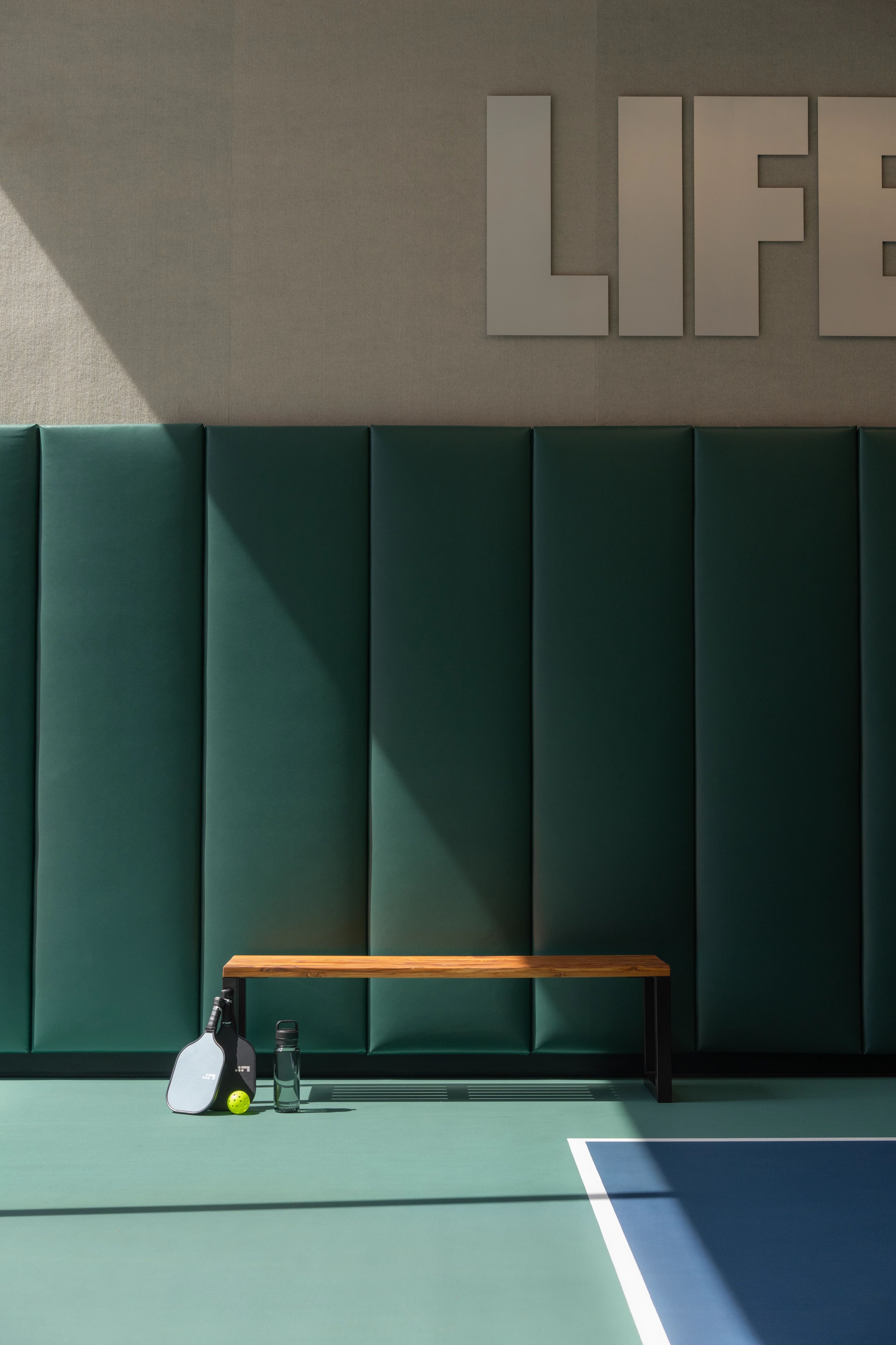 pickleball paddle sitting by a bench