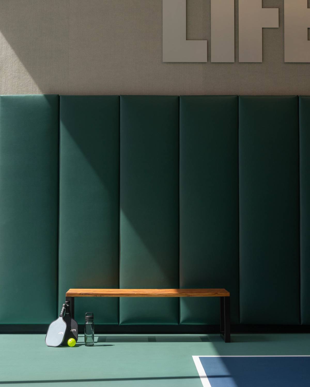 pickleball paddle sitting by a bench