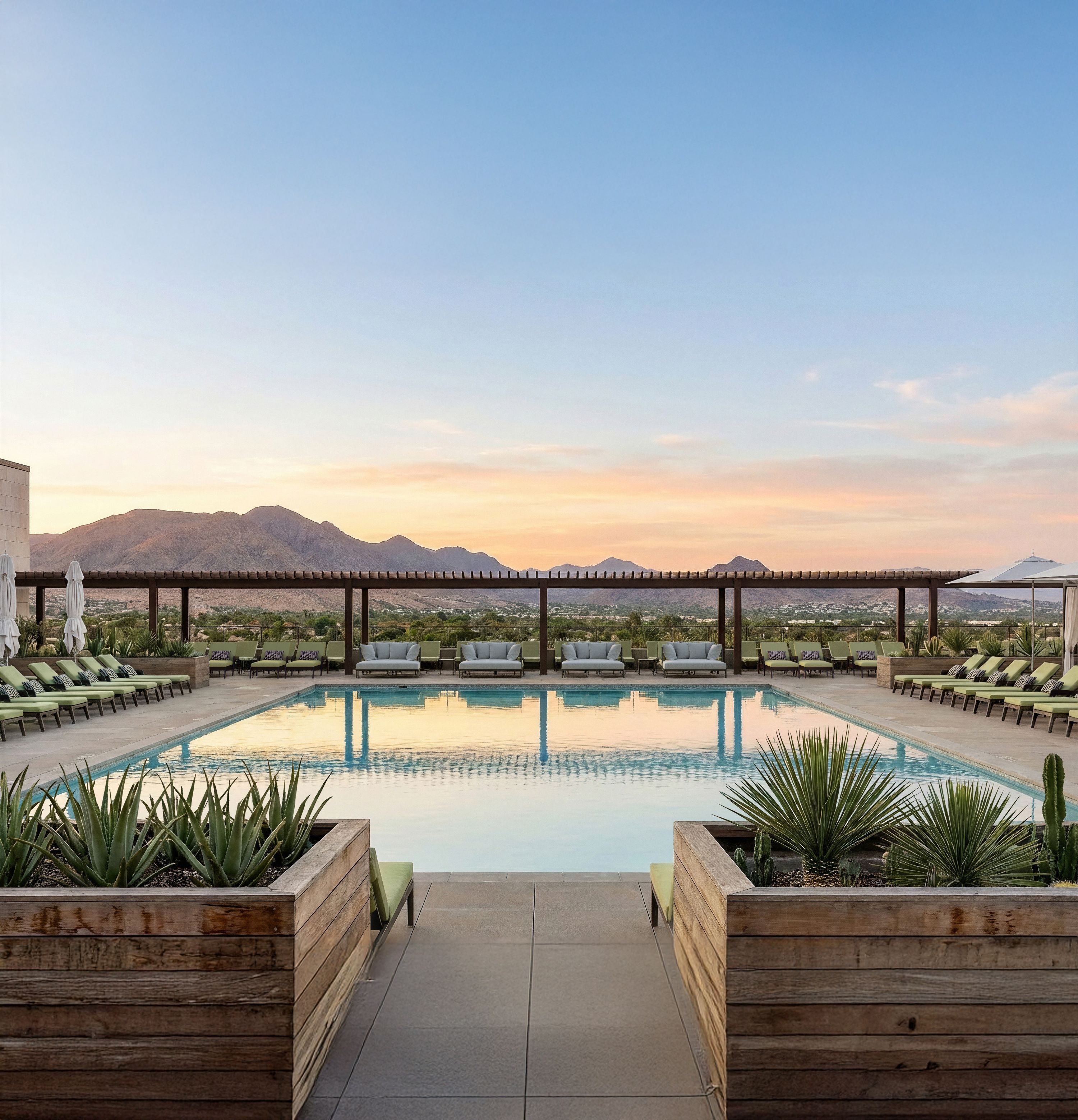 Calm outdoor pool facing the mountains and sunset.