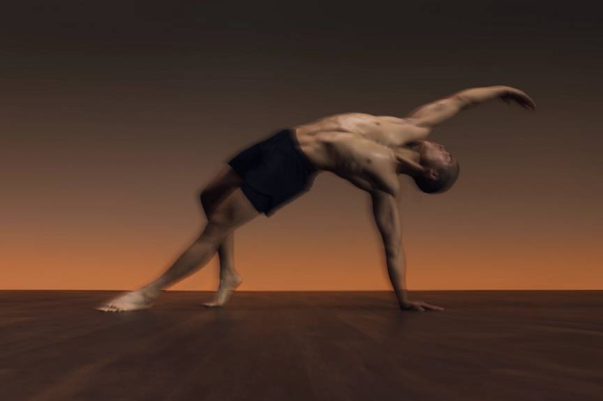 Man in side angle pose with chest opener during flow yoga class at Life Time