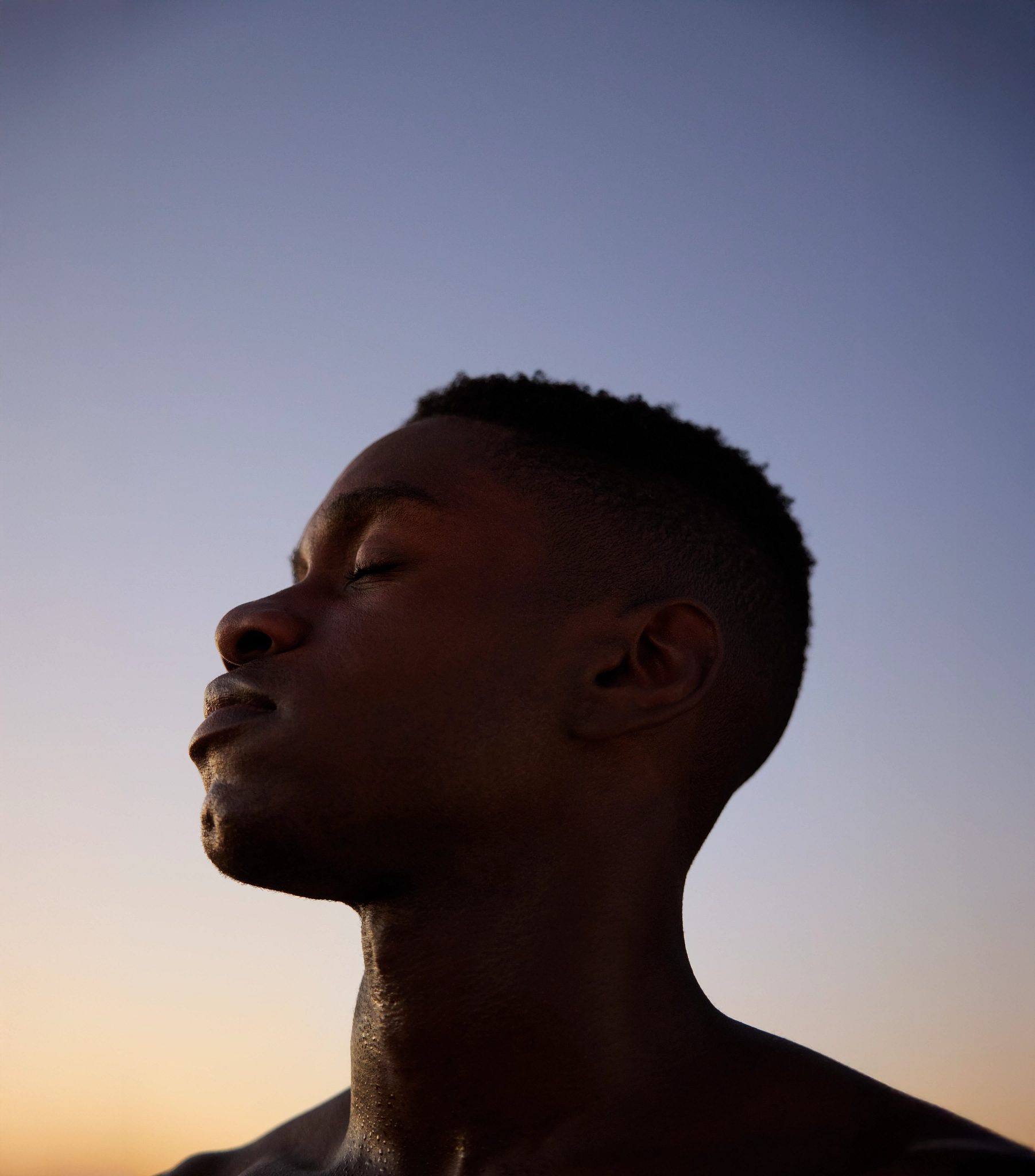 man looking up at the sun