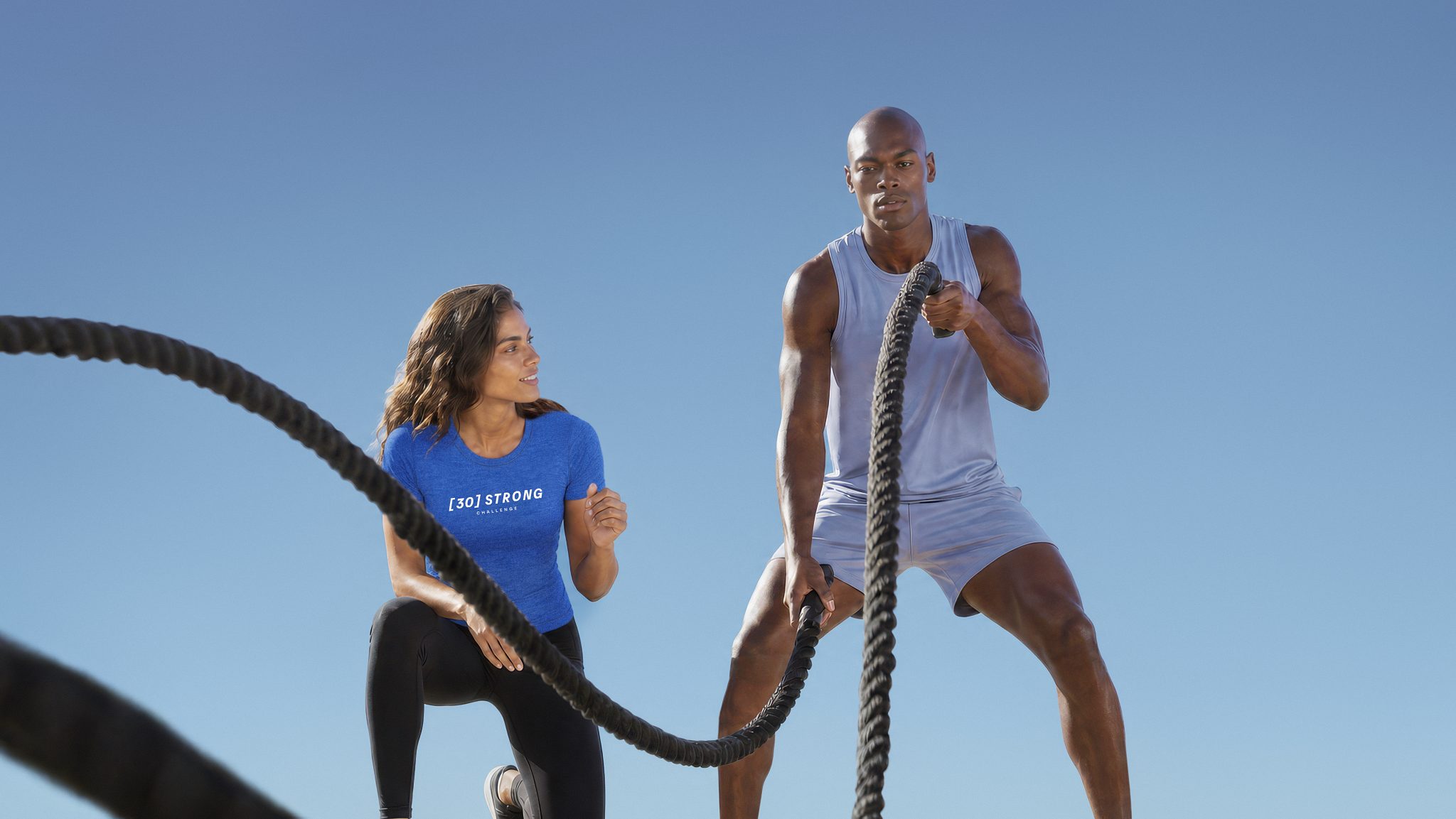 A Dynamic Personal Trainer assisting her client with form during strength training